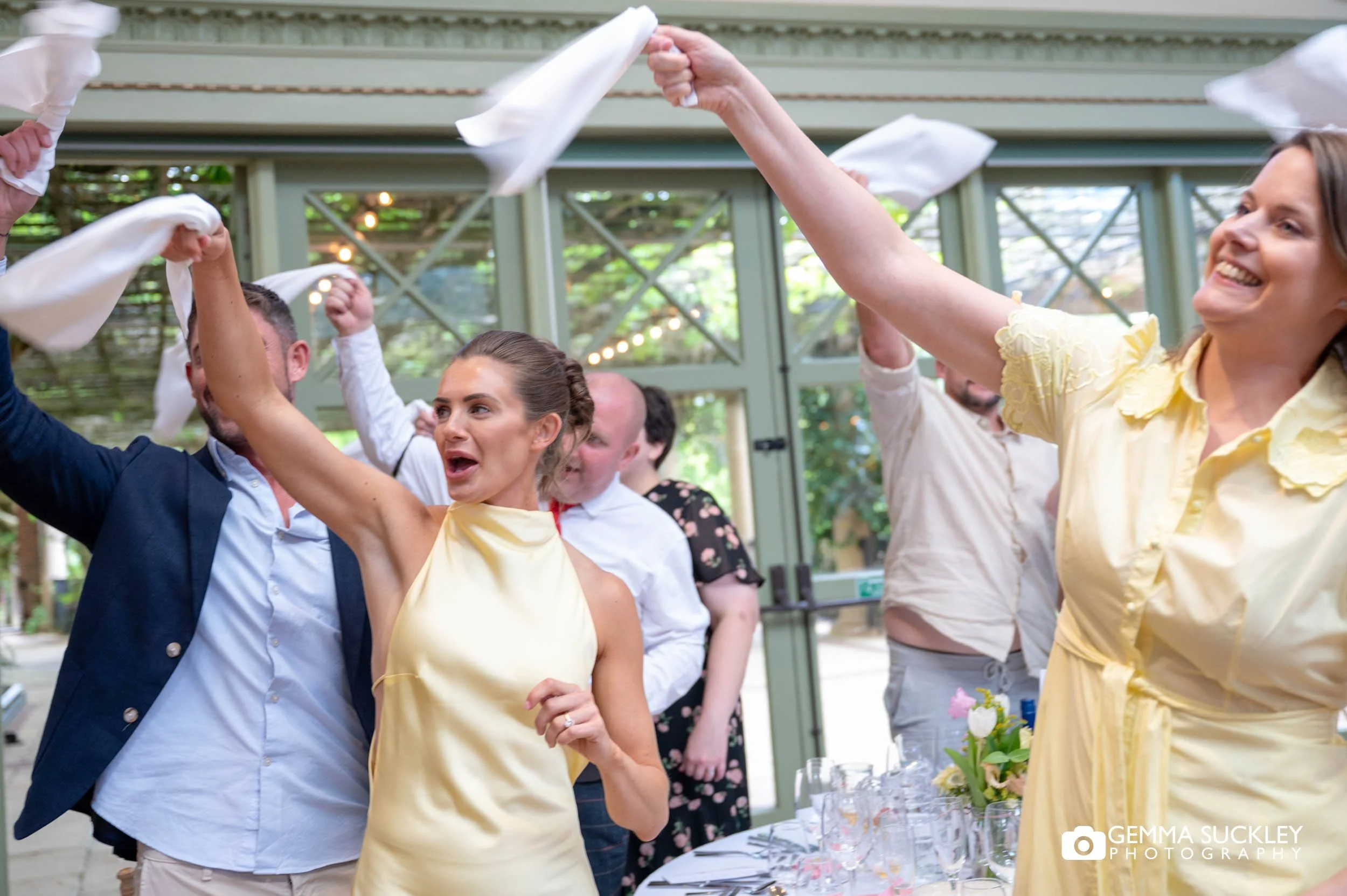 wedding guests waving napkins