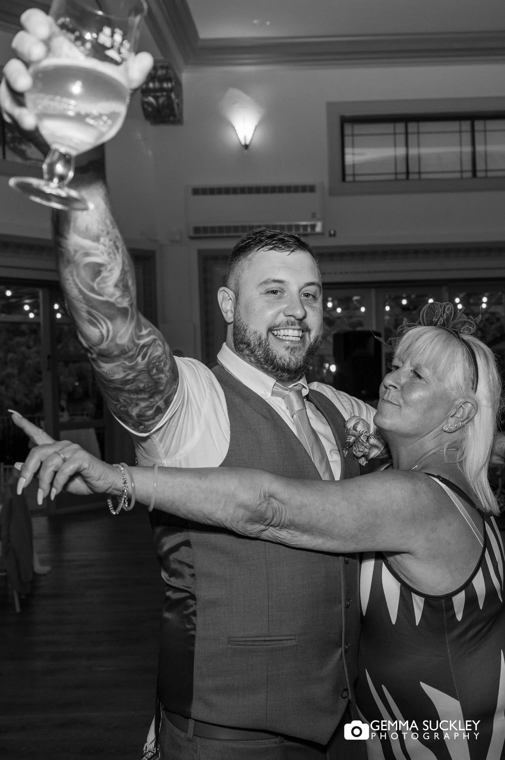groom sharing a dance with his mum