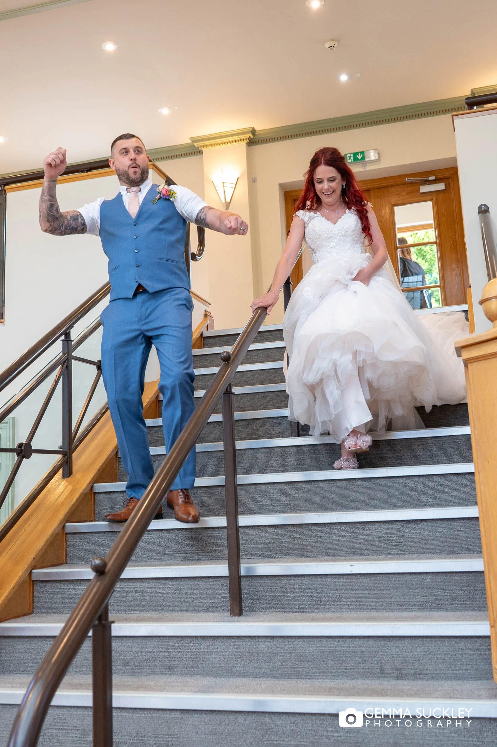 bride and groom walking down the sun pavilion stairs