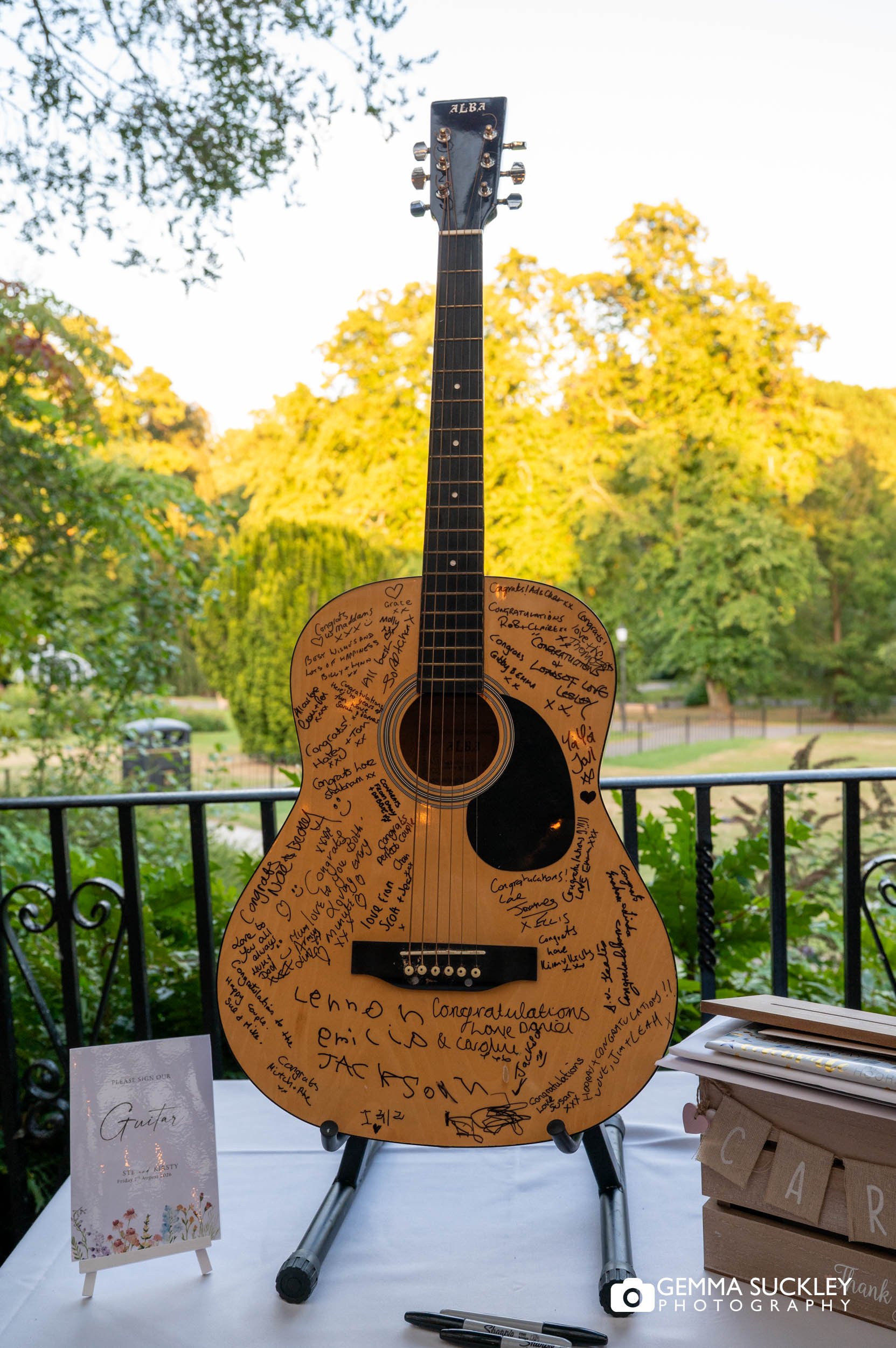 Guitar used as a unique wedding guest book on the balcony of The Sun Pavilion