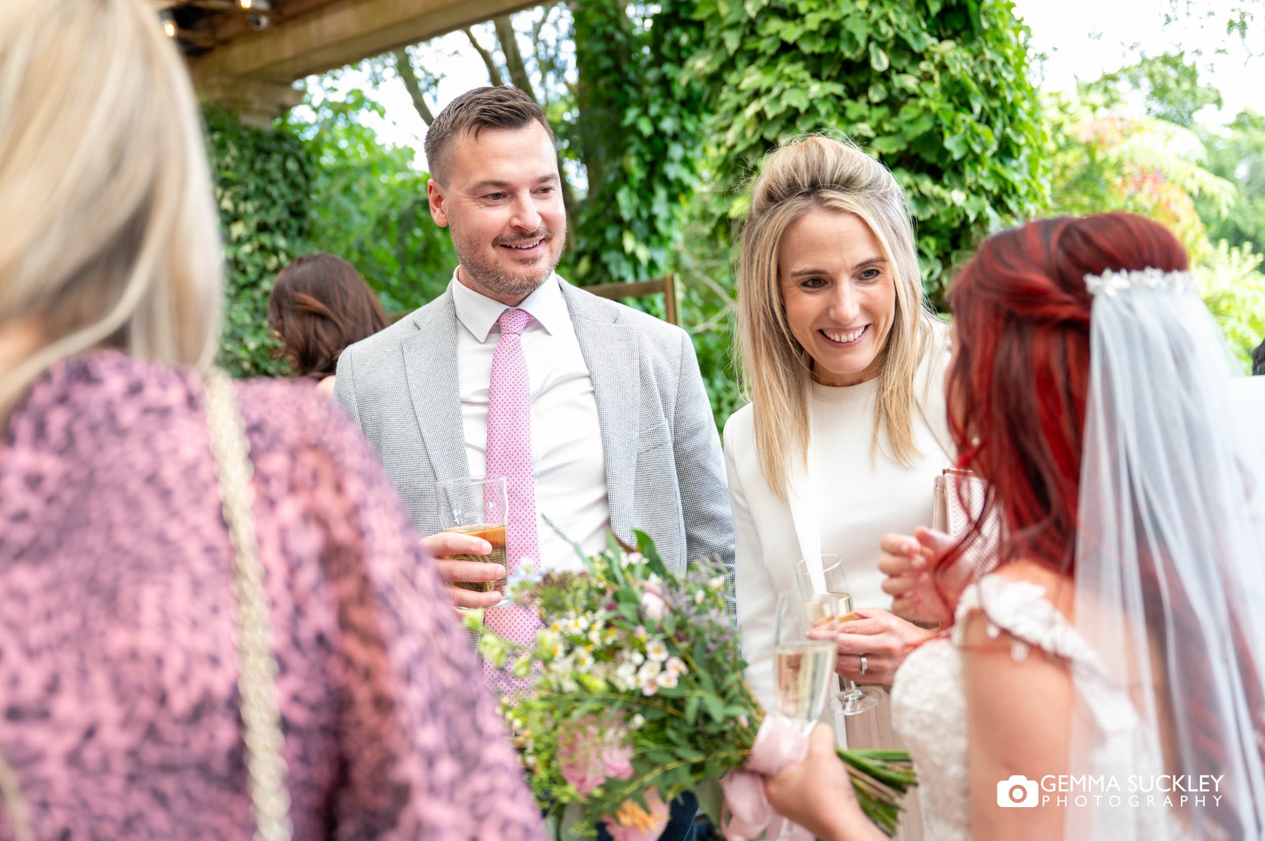 wedding guests talking to the bride