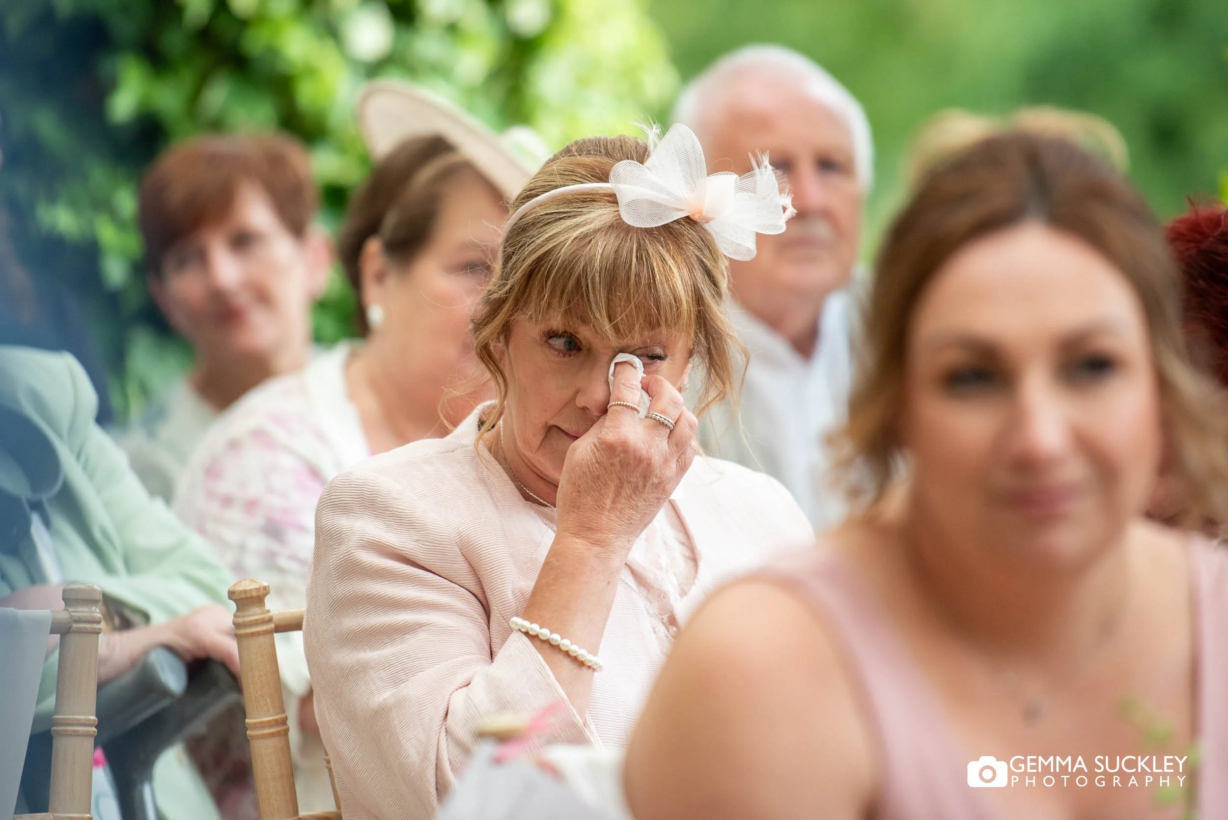 mother of the bride wiping away a tear