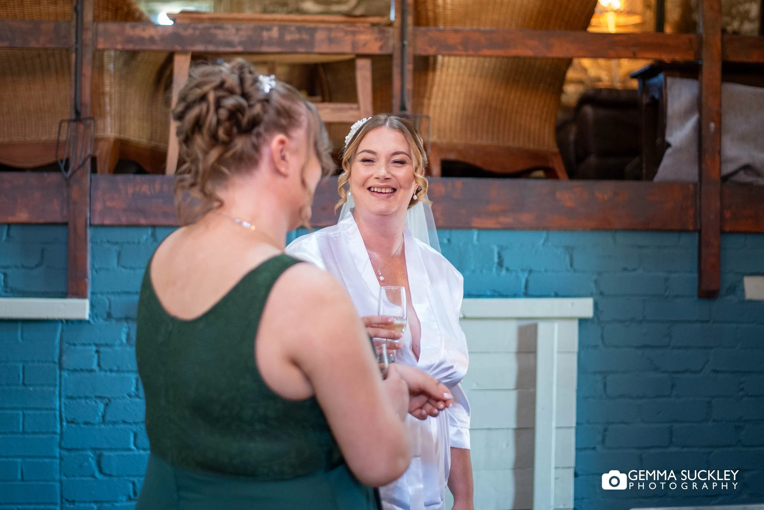 Bride getting ready with her bridesmaid
