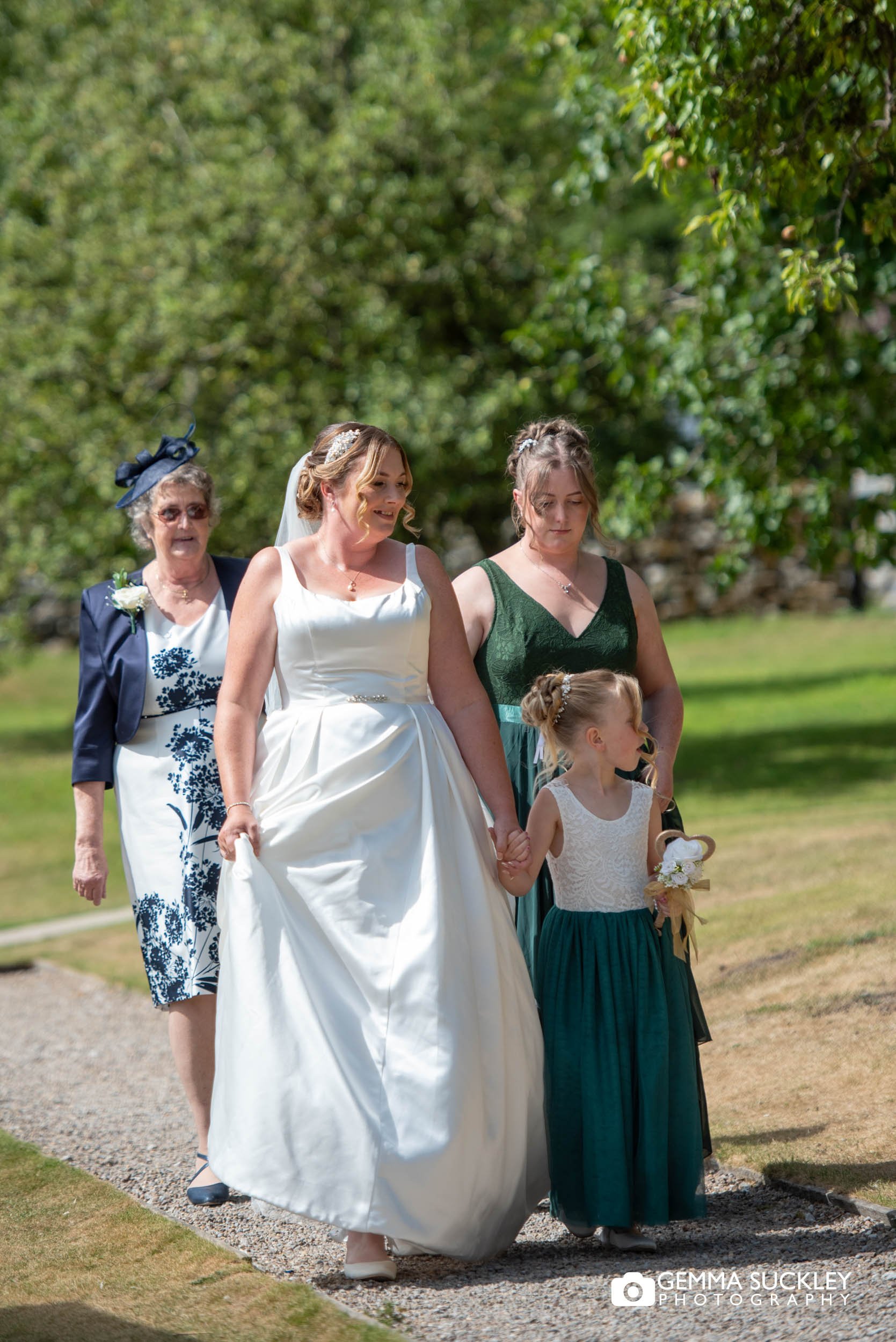 bridal party walking to the priests house