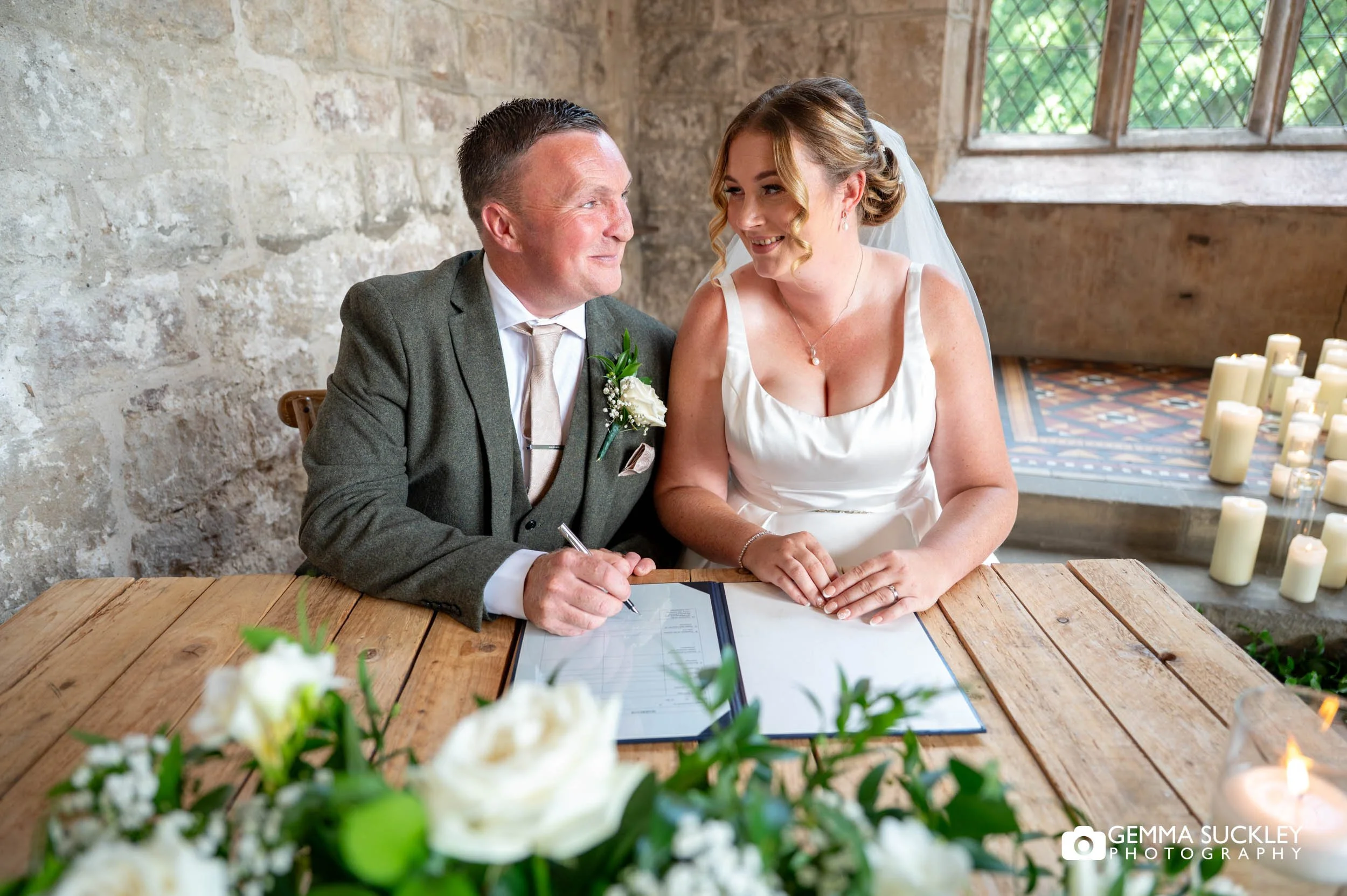 bride and groom signing the register 