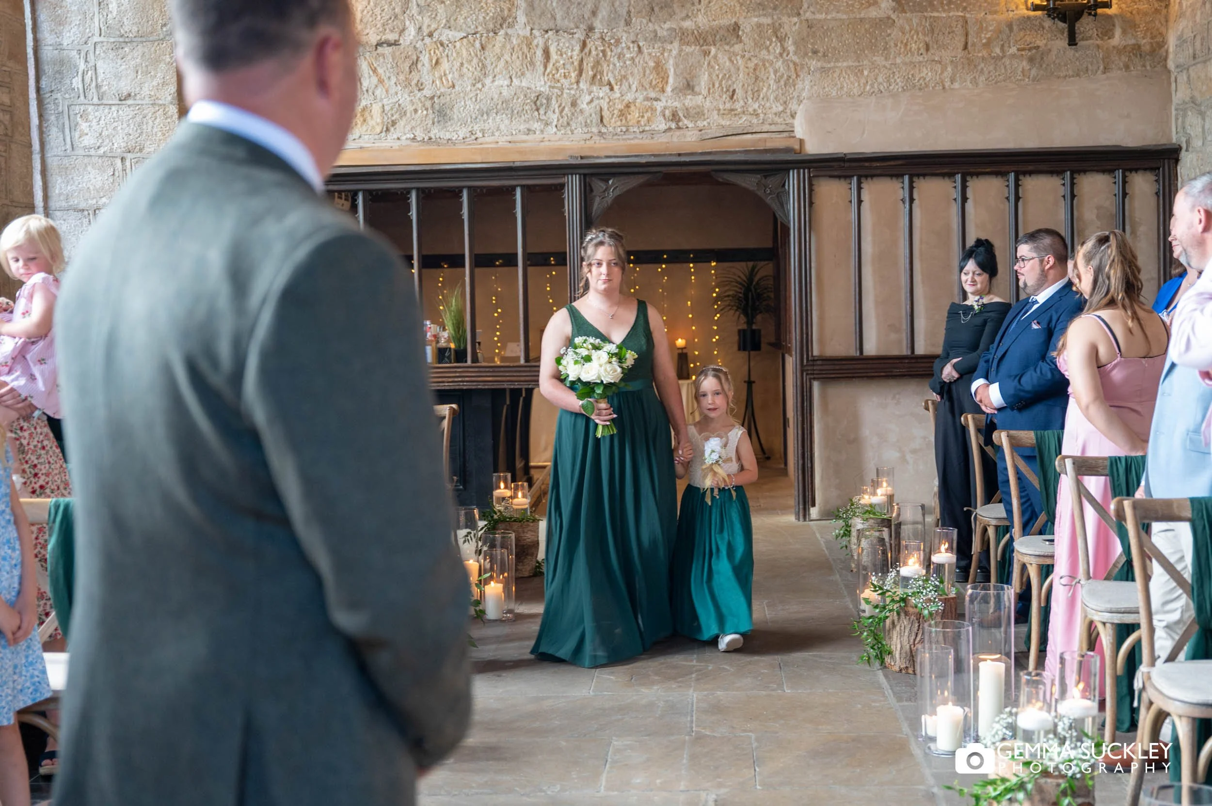 bridesmaid and flower girl walking down the aisle 