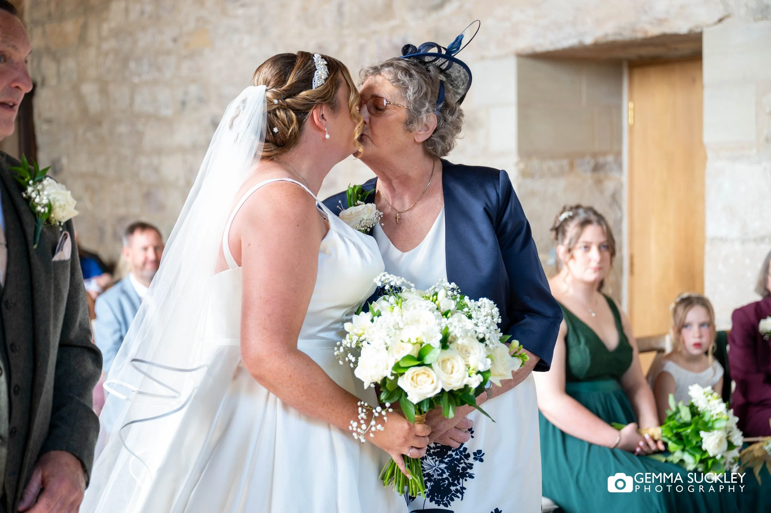 mum kissing the bride giving away her daughter