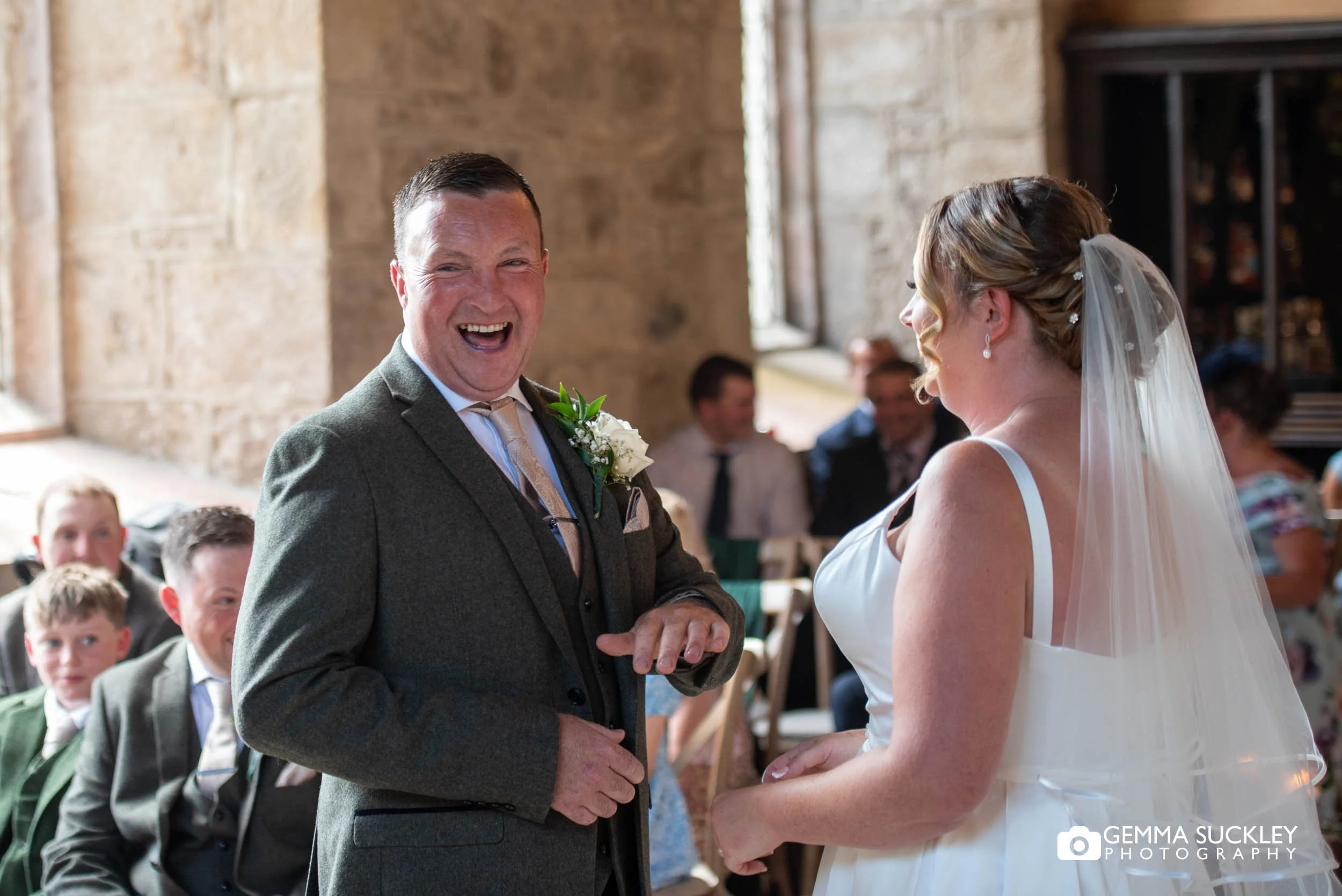 groom laughing during ceremony