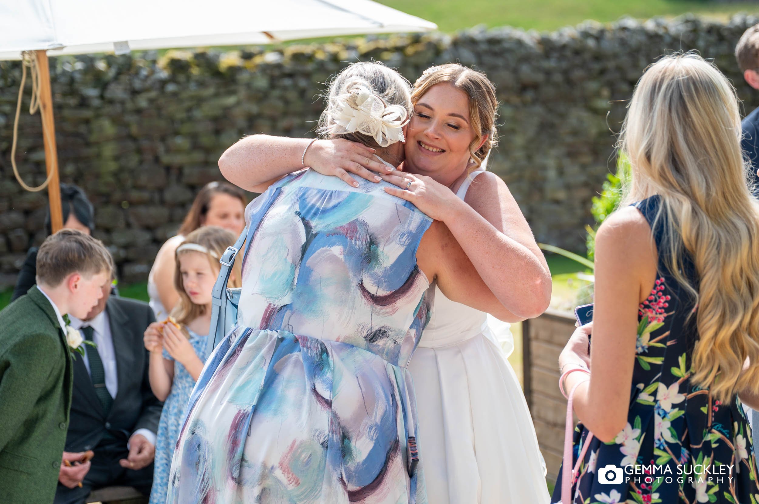 bride hugging guests