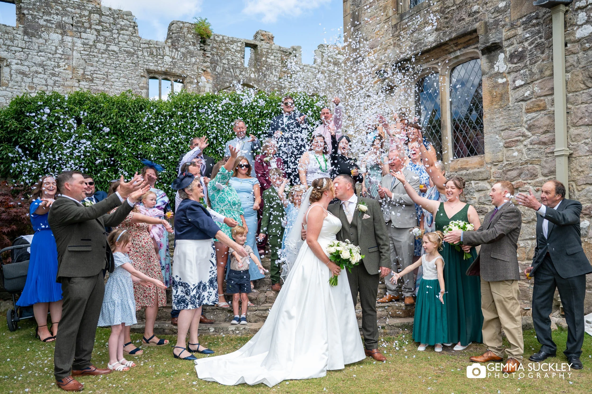 all guests throwing confetti outside The Priests House