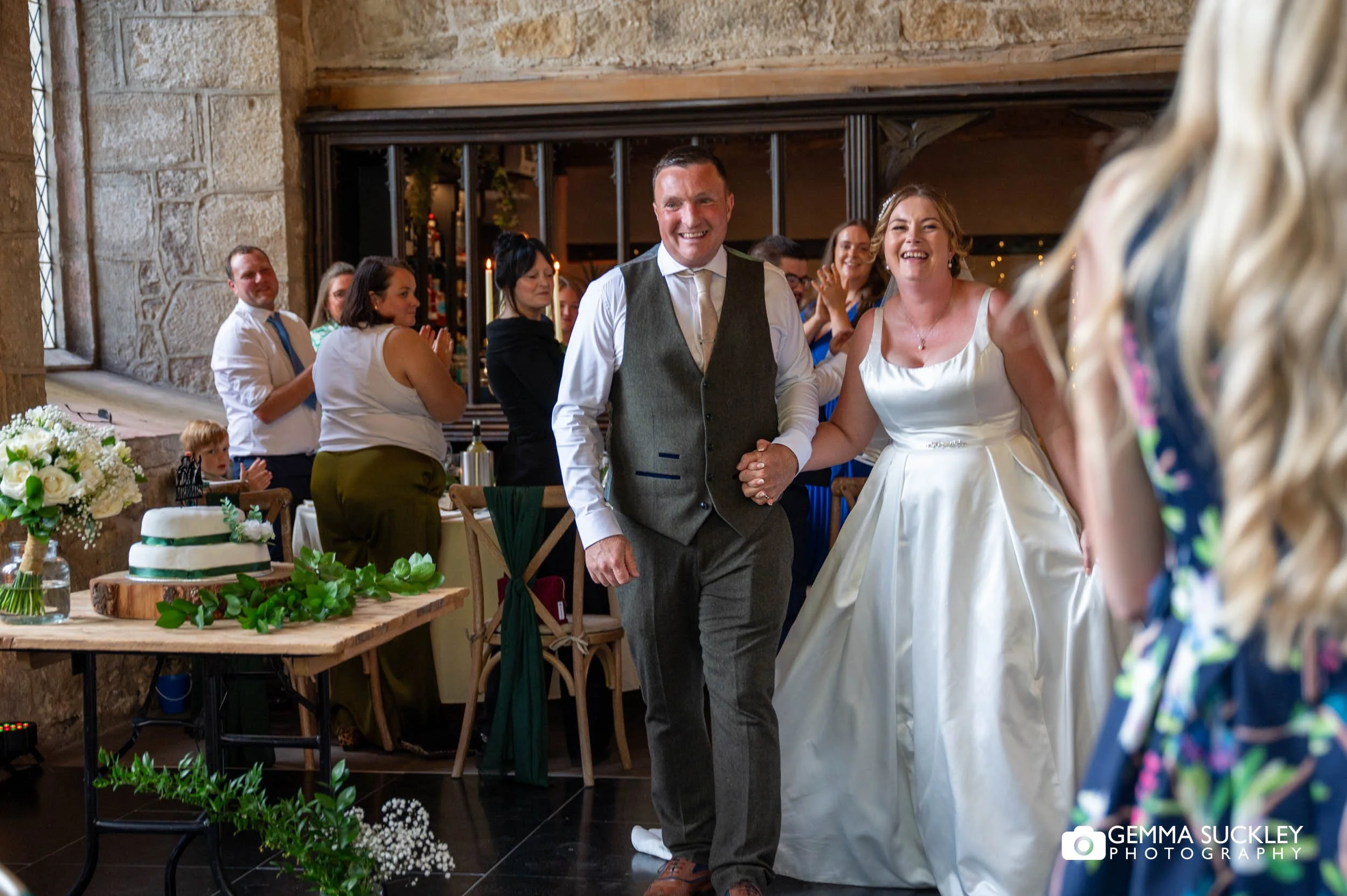 bride and groom entering the wedding breakfast