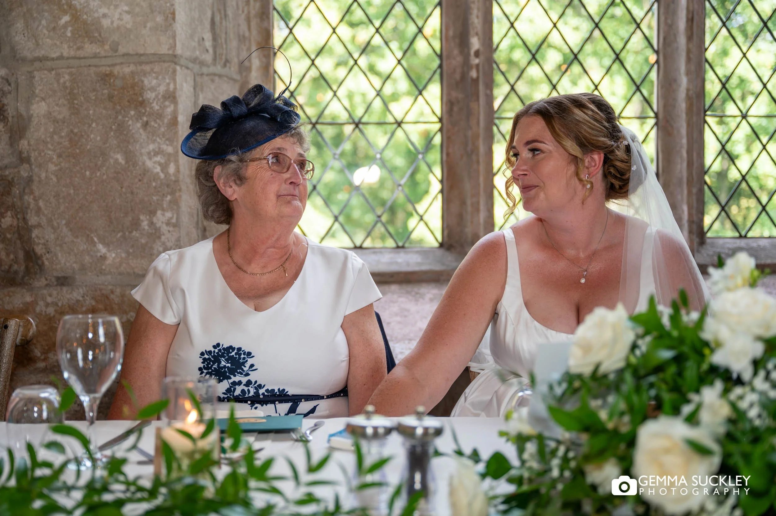 bride and mother share a look during speeches