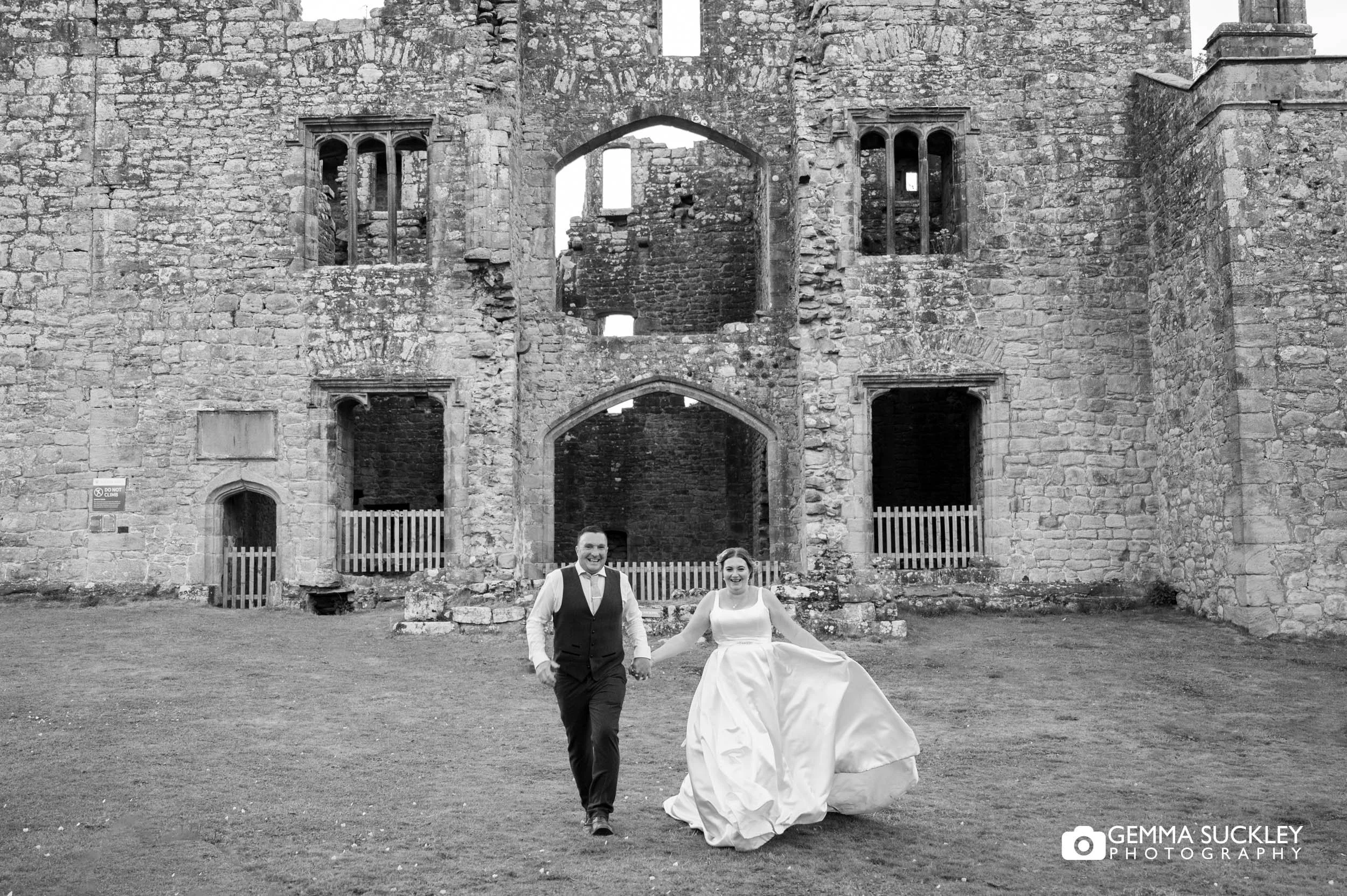 married couple running in front of barden tower