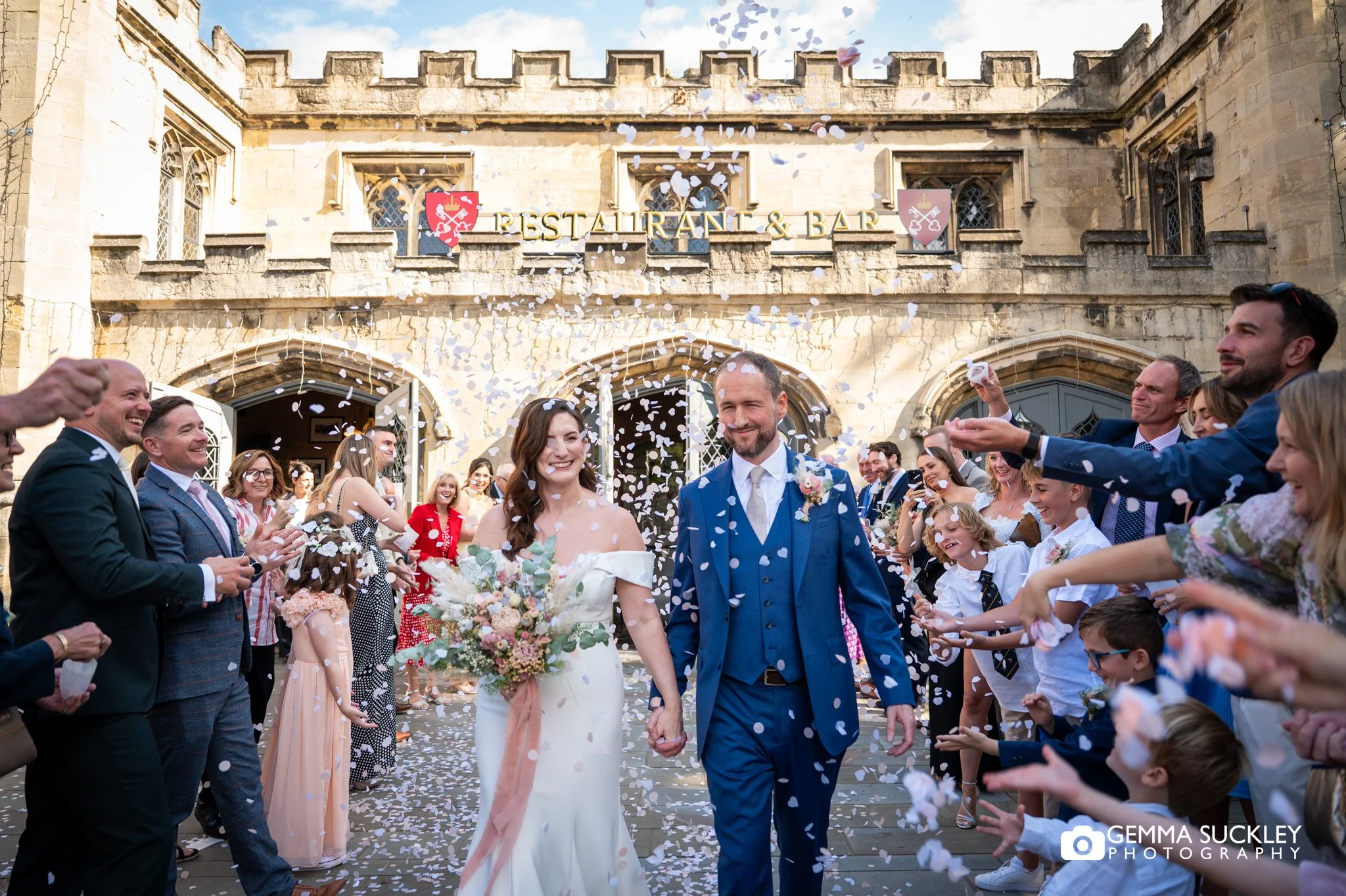 just married outside the york minster refectory while guest throw confetti