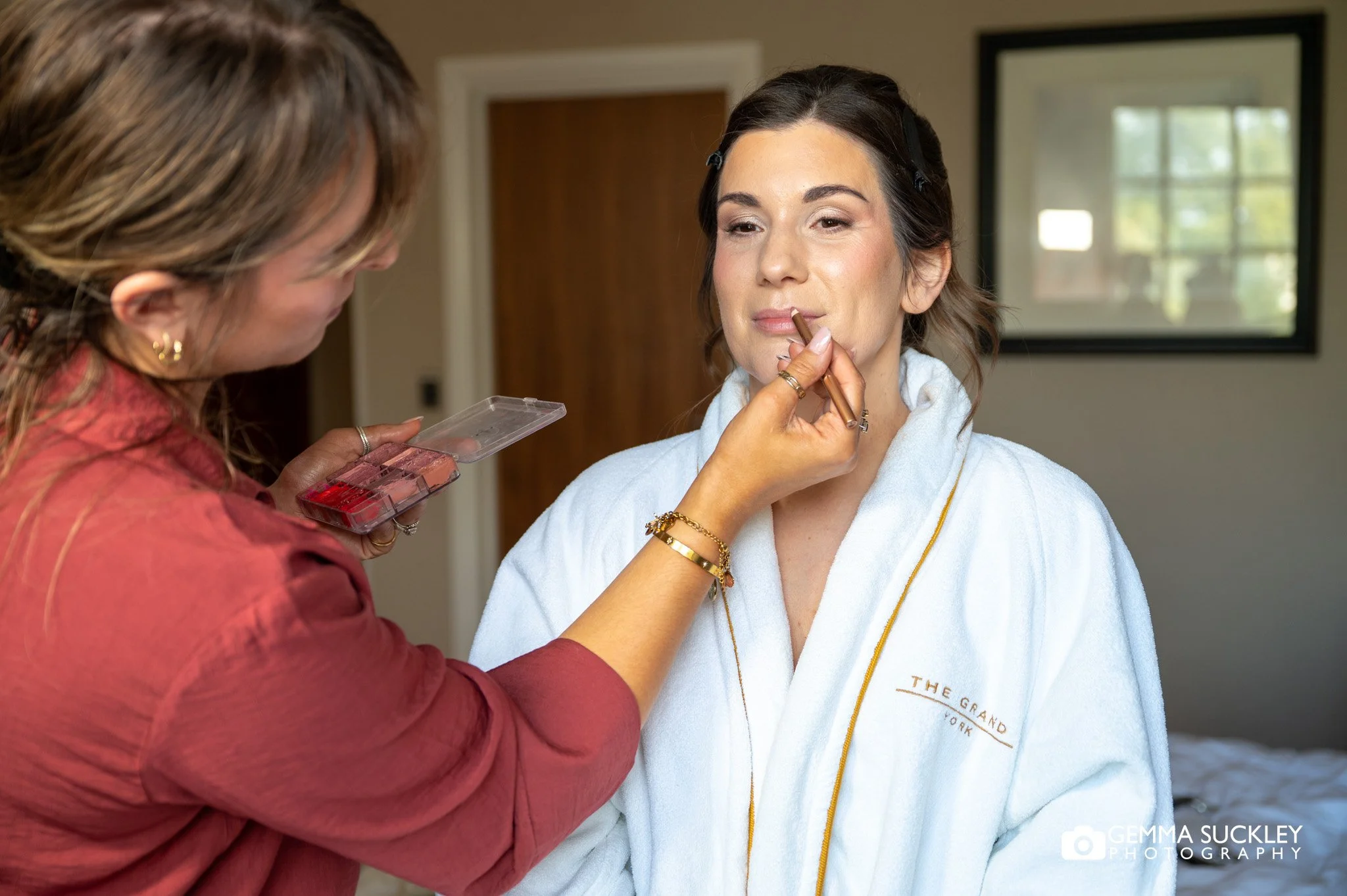 bridesmaid having her makeup applied
