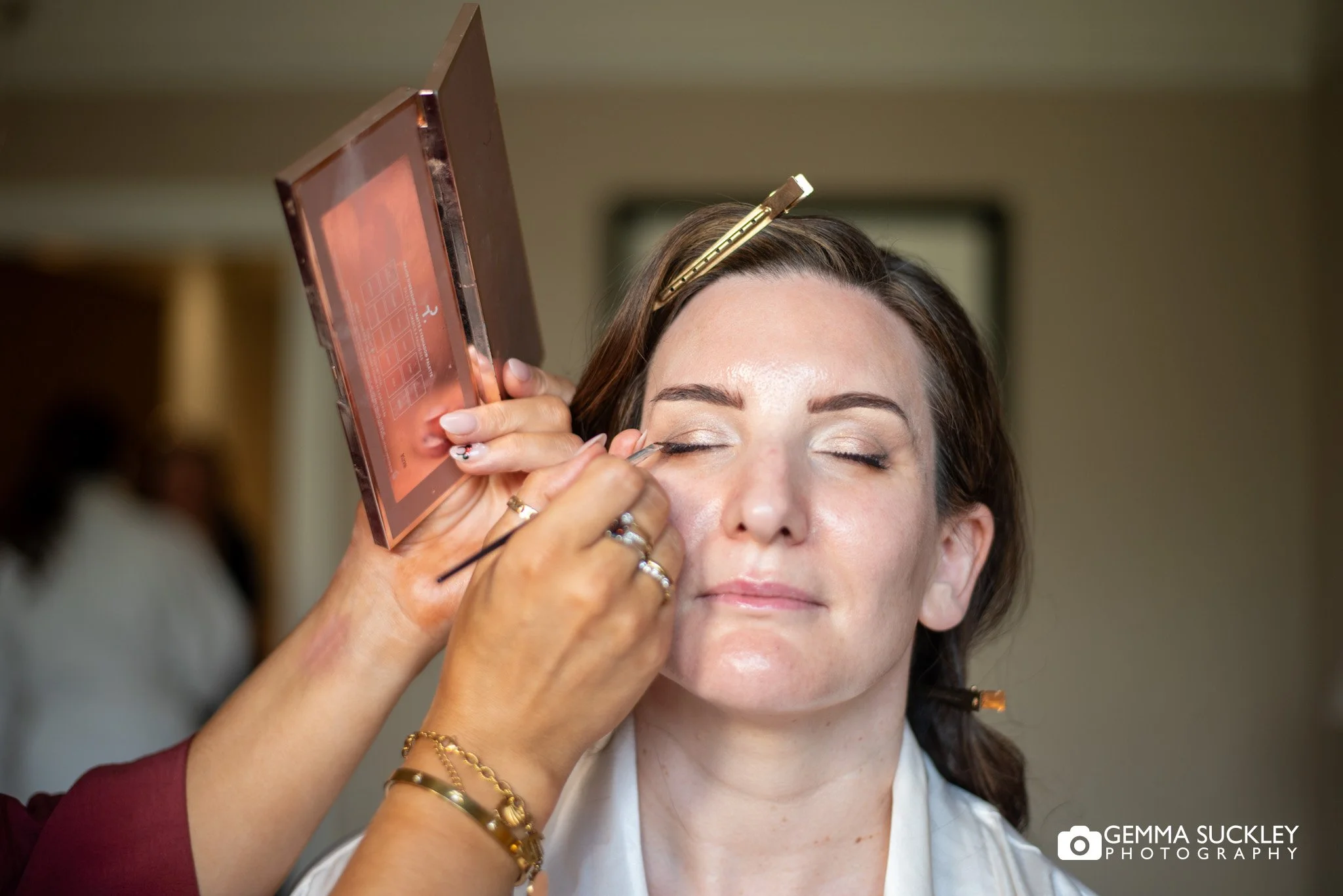bride having makeup applied