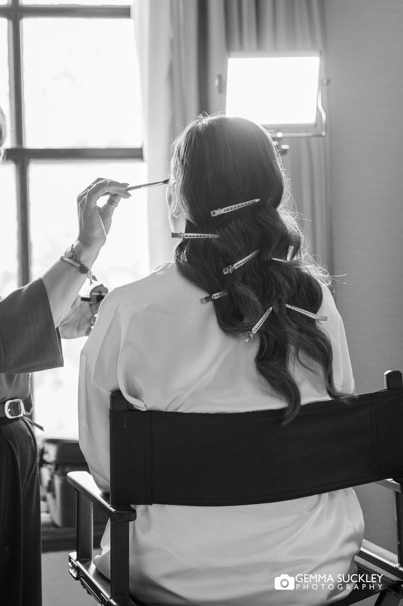 bride sat in makeup chair