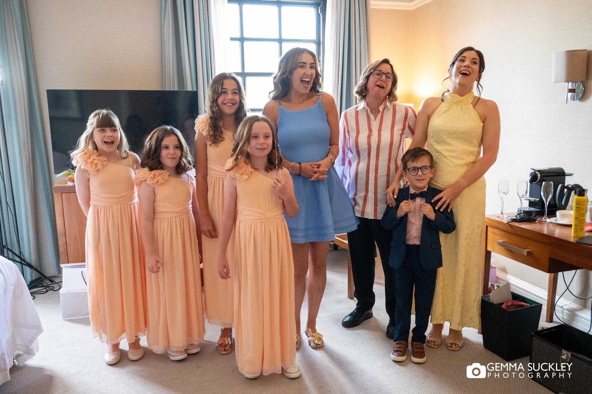 flower girls and bridesmaid reaction to seeing the bride in her wedding dress