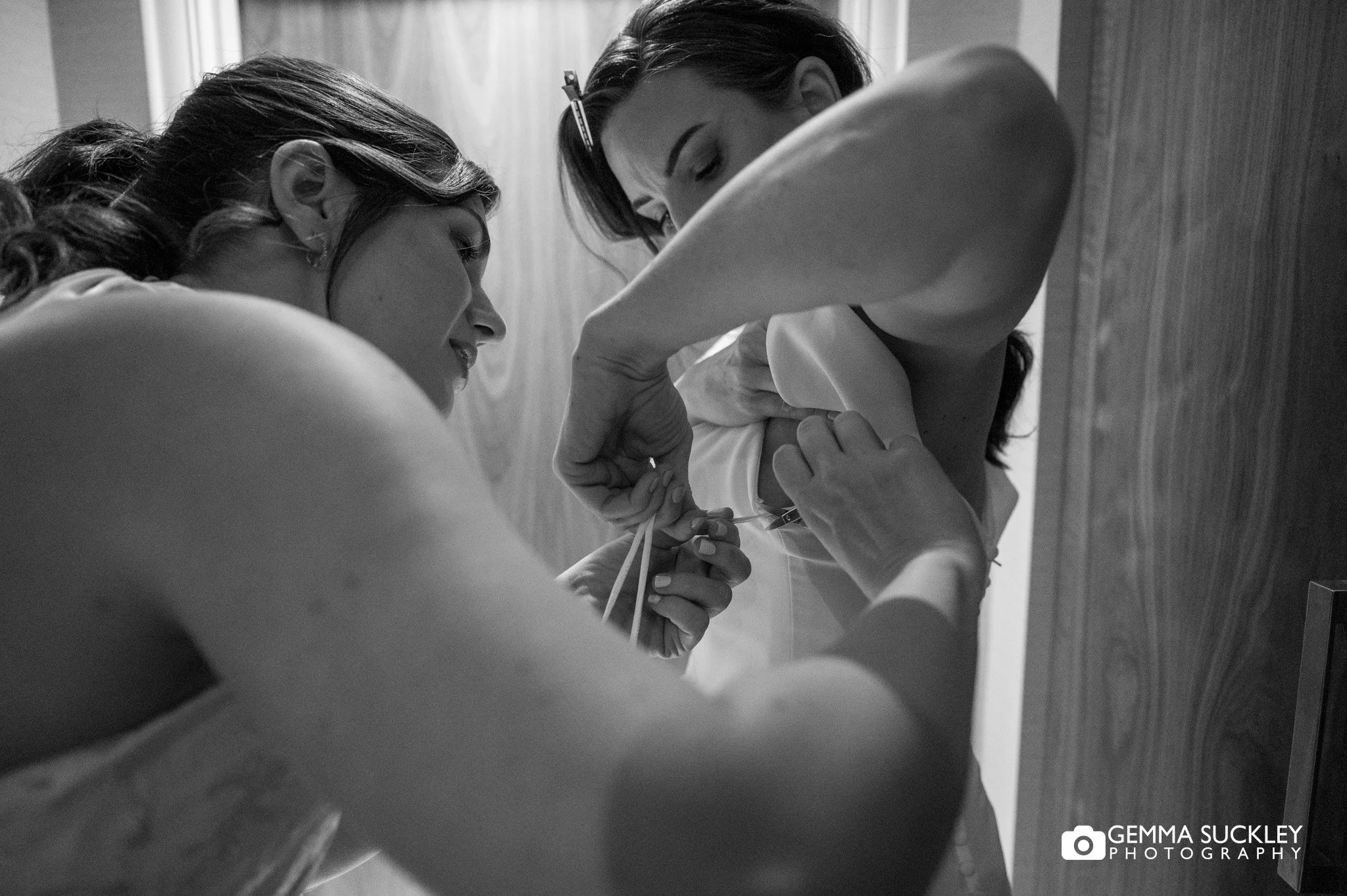 bride getting into dress