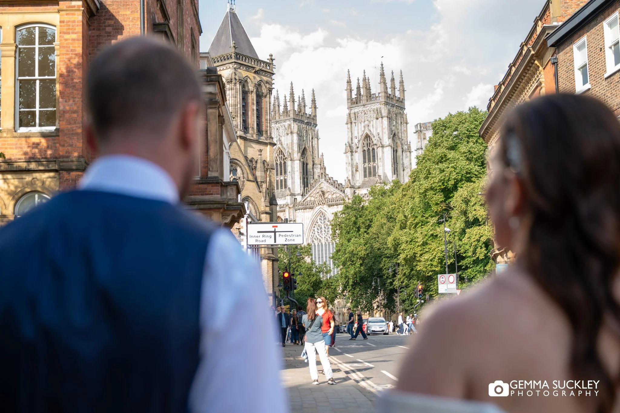 just married couple walking towards york minster