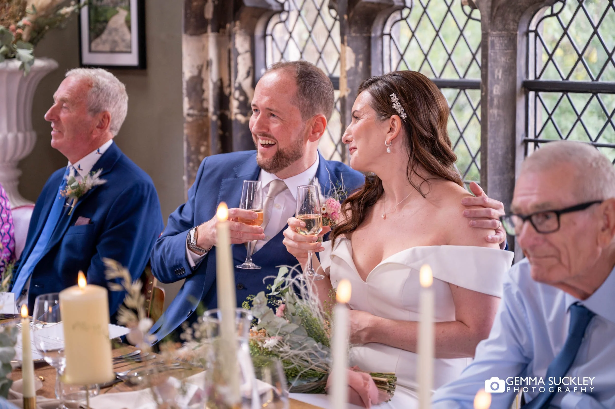 bride and groom laughing at speeches