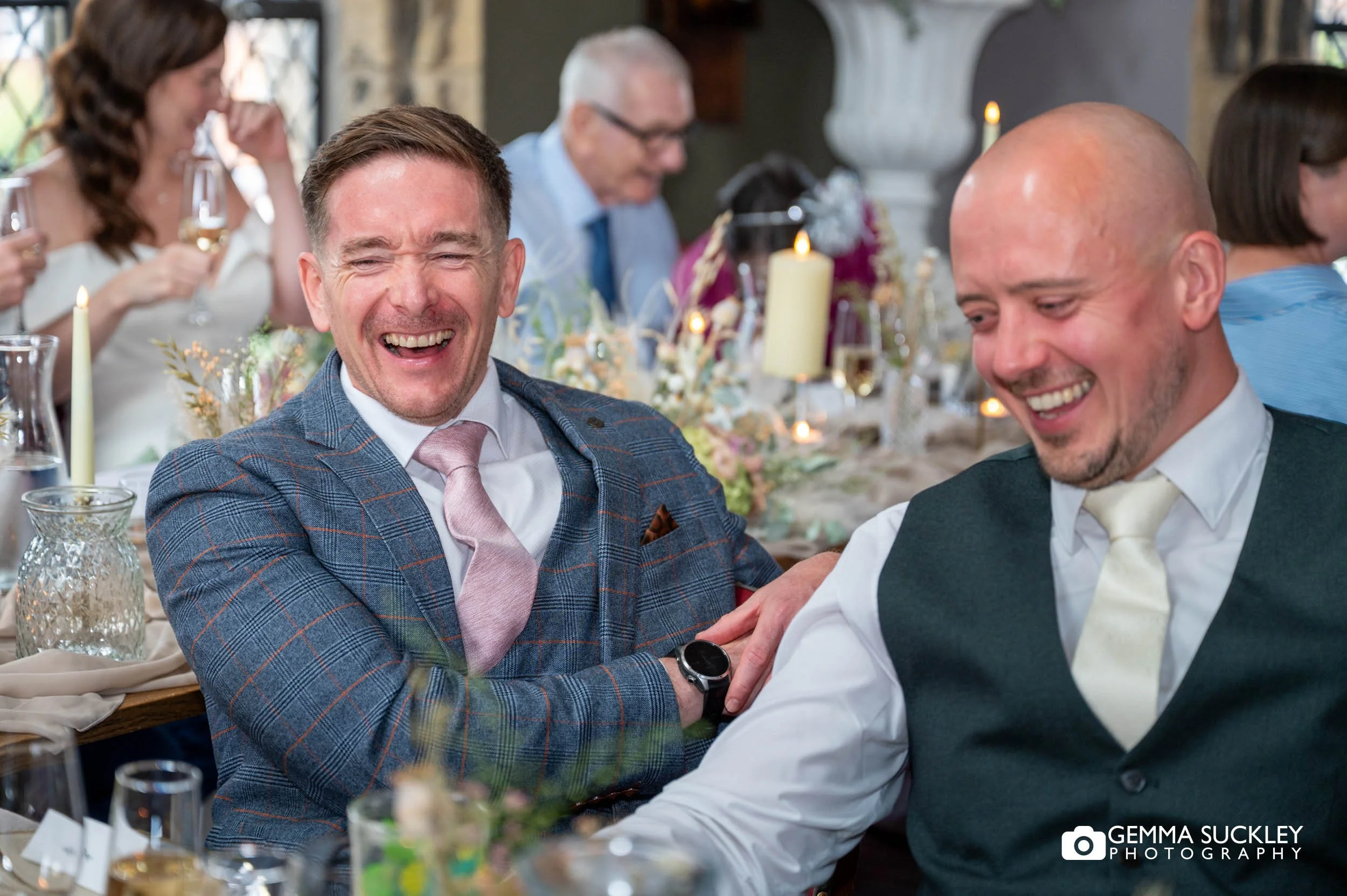 guests laughing during speeches