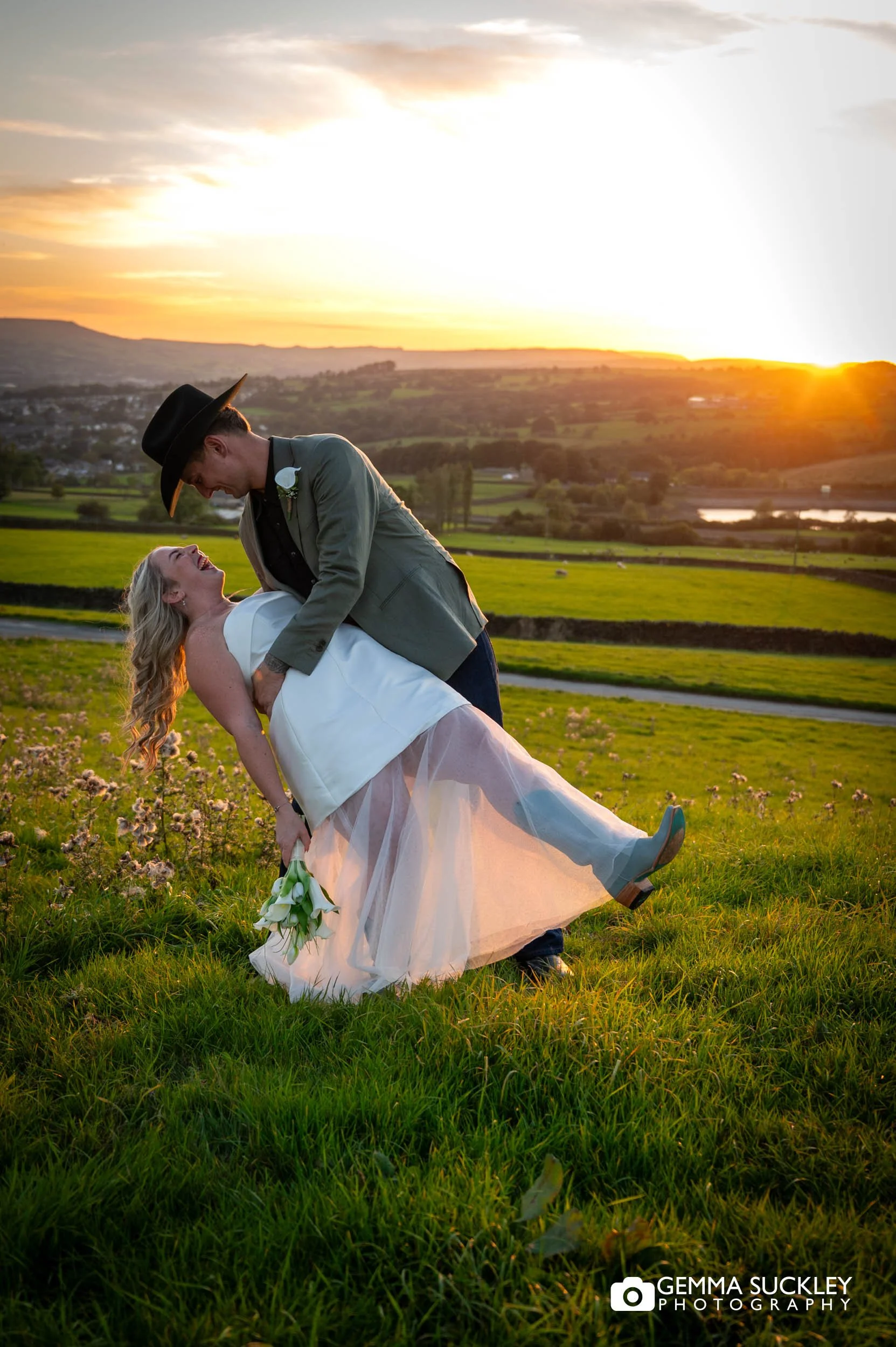 the groom about to kiss his bride at sunset