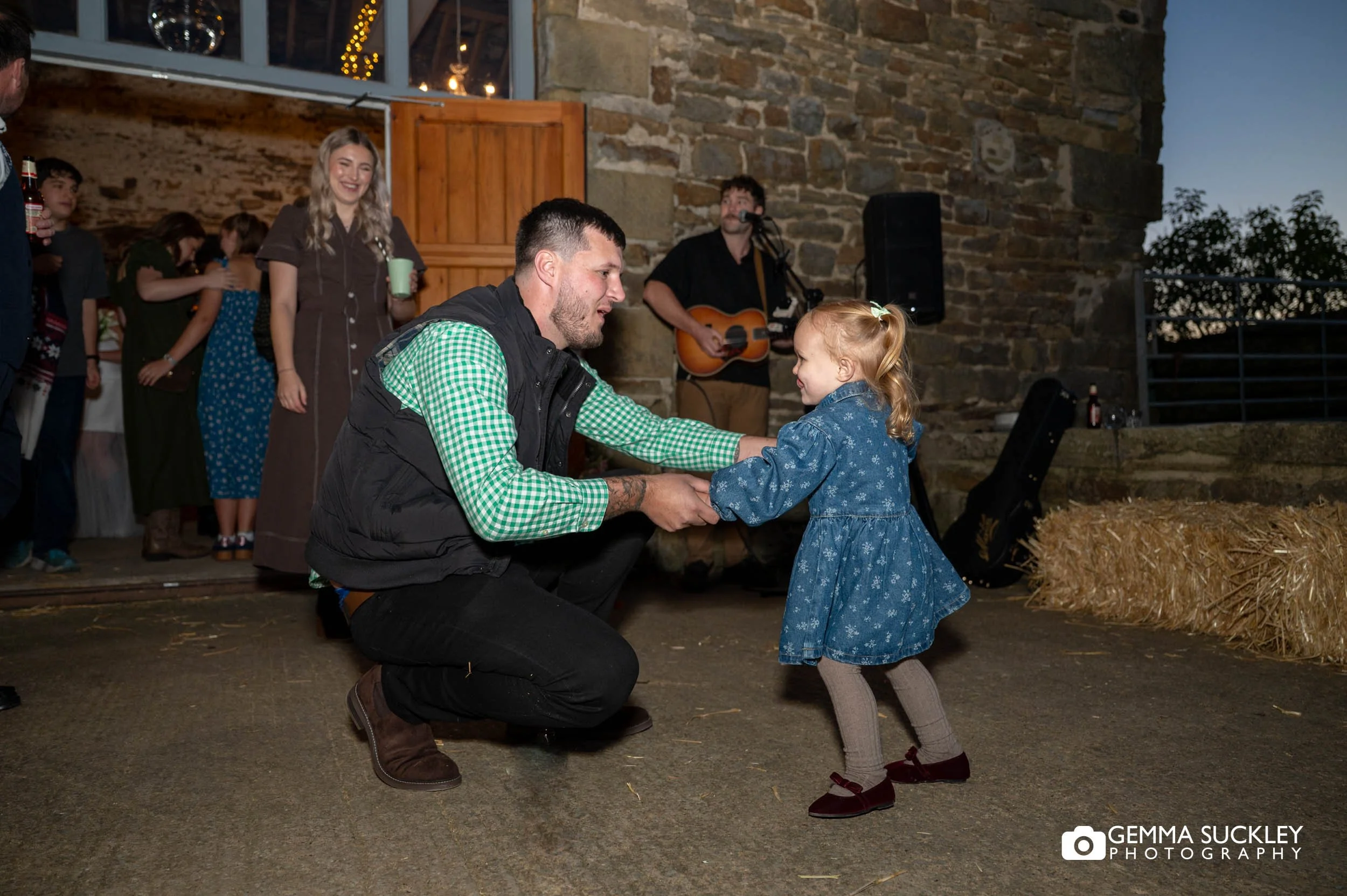 father and daughter dancing outside a wedding barn