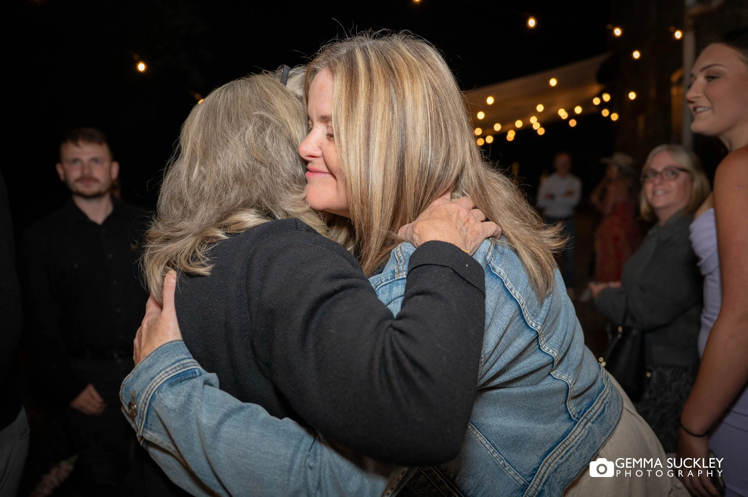 wedding guests hugging