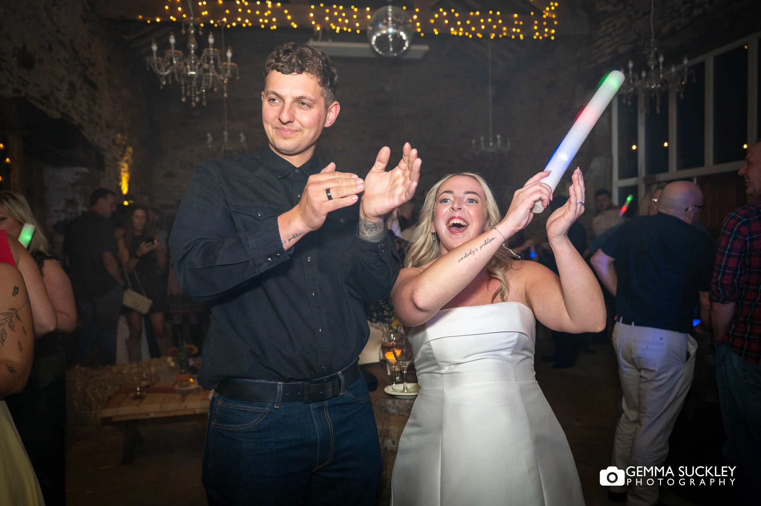 the married couple cheering on the dancefloor 