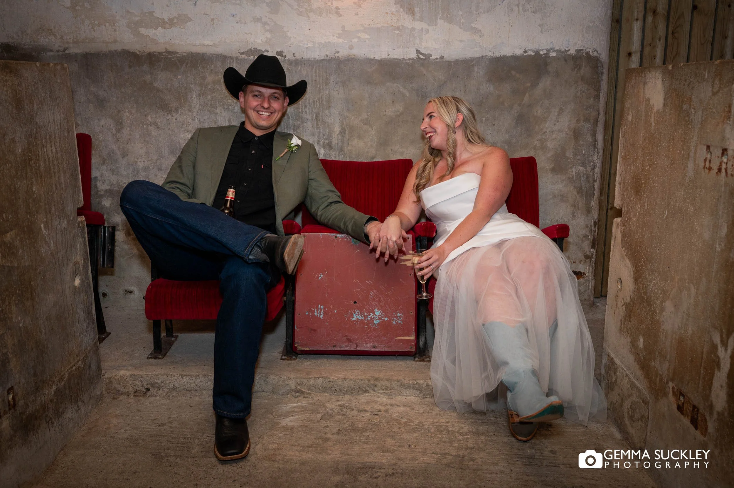 just married couple sitting on old cinema seats 