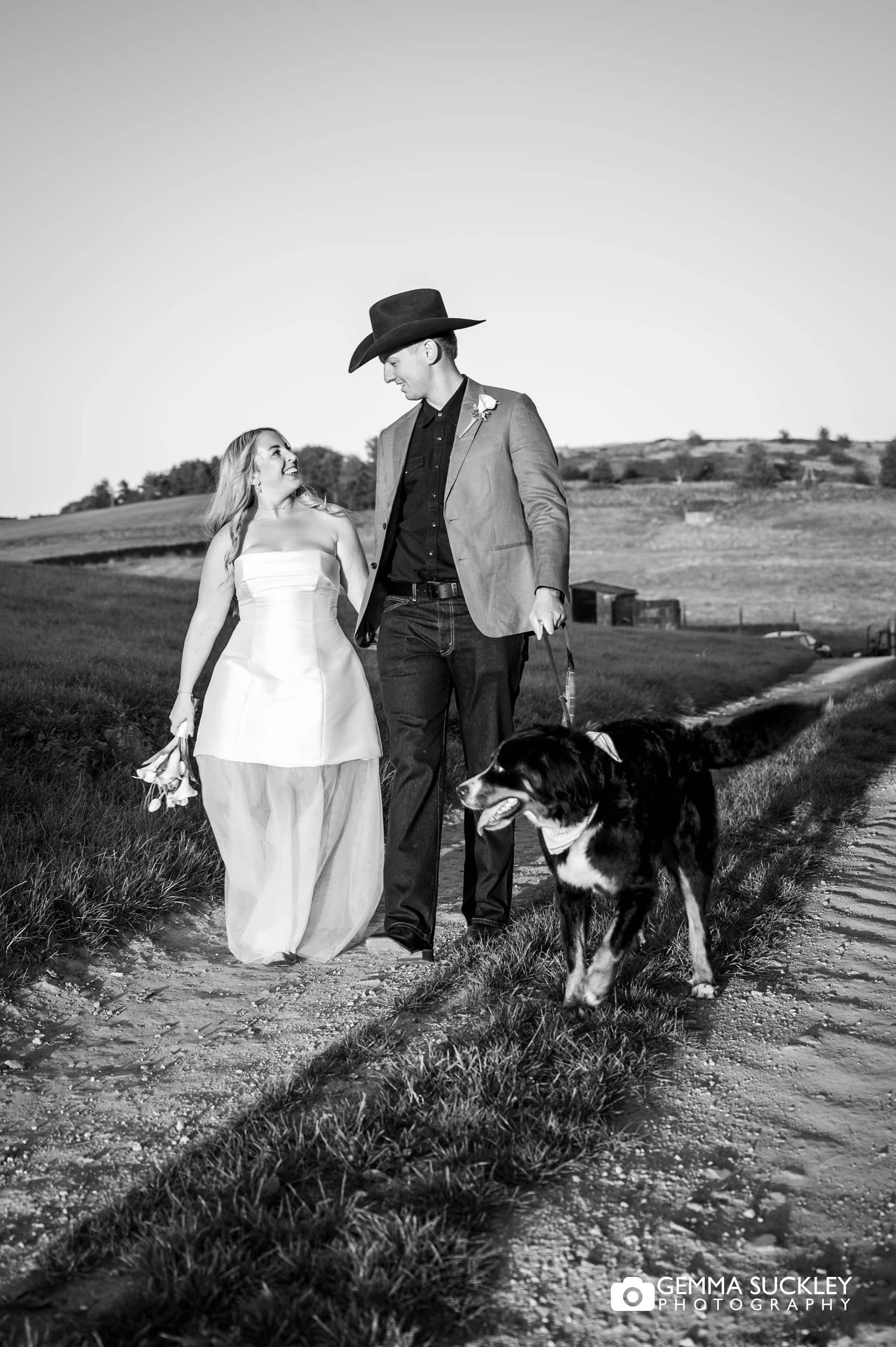 married couple walking with their dog