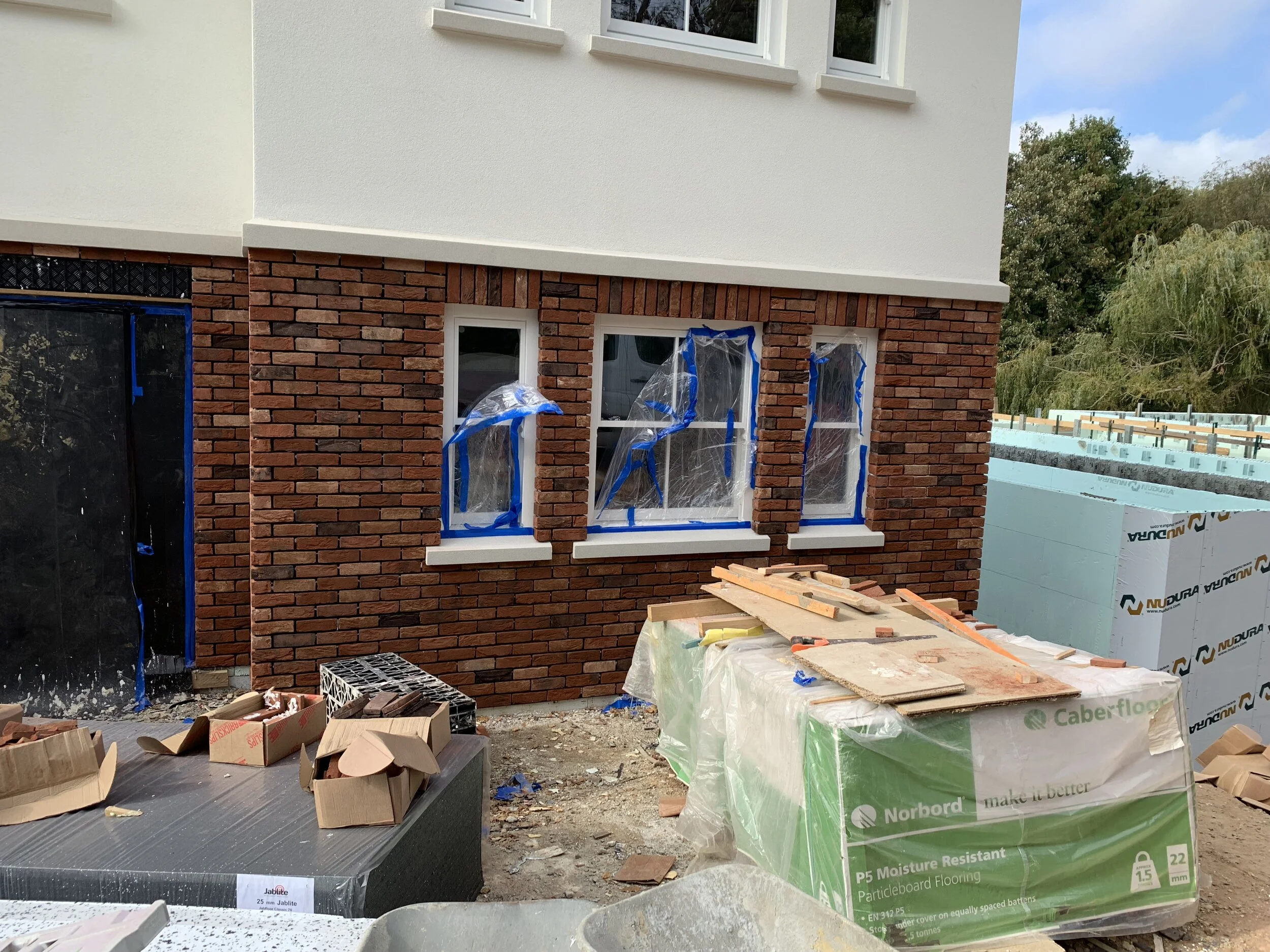 a real brick slip on a preparatory  brick slip fixing system was then installed to the front ground floor level along with double glazed wooden sliding sash windows