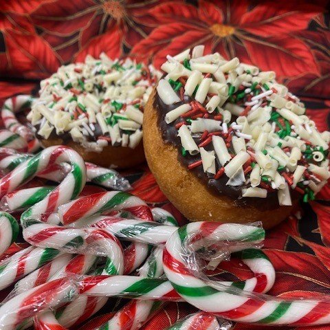 Special delivery from the North Pole for the month of December! Have your elf bring you one of these adorable donuts.  These are white cake donuts, with peppermint chocolate fondant and topped with white chocolate curls and festival sprinkles.  Lets 