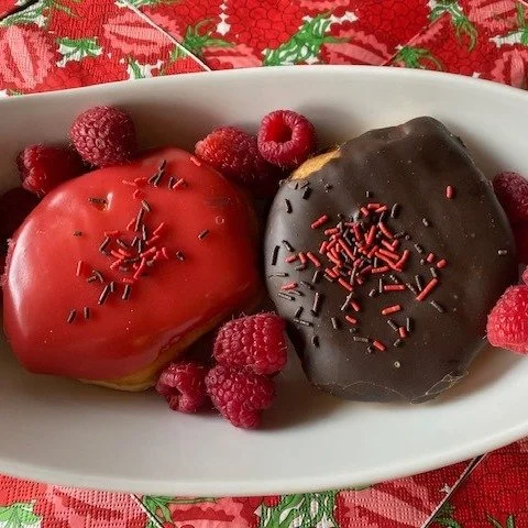 Guess who has a buddy?! Our chocolate raspberry (chocolate fondant) has a friend...Vanilla Raspberry Donut.  This new donut is wearing a bright raspberry coloured fondant with sprinkles and is feeling full with a generous serving of raspberry filling