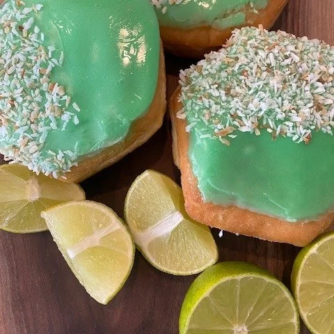 Lime in the Coconut donut alert! 🚨 Don't say we didn't warn you... this baby's got a zesty lime jelly filling, vanilla fondant, and coconut on top! It's like a tropical vacation in every bite. You can just eat a donut and pretend you're on island ti