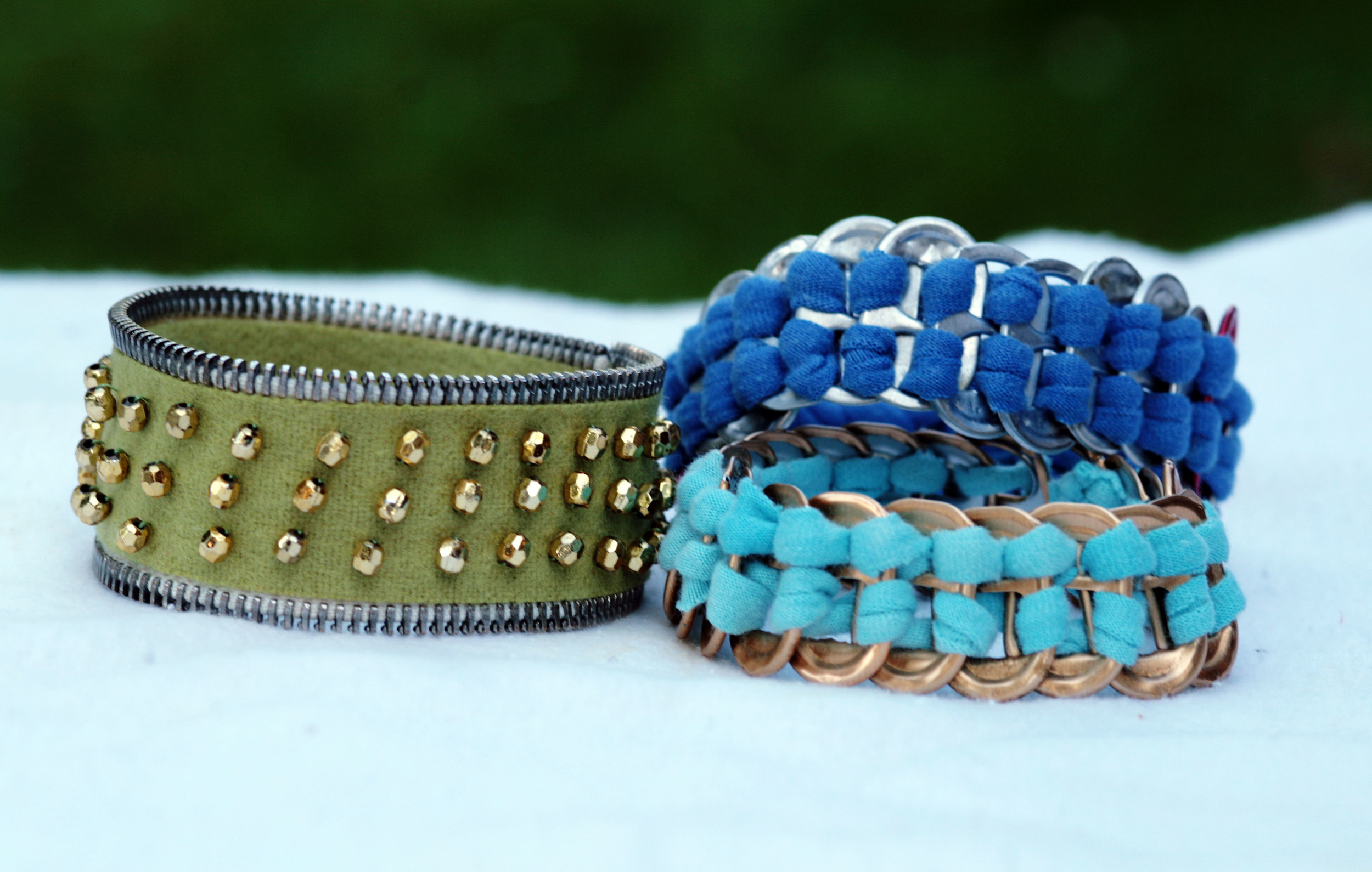 Bracelets made of a zipper and soda tabs.