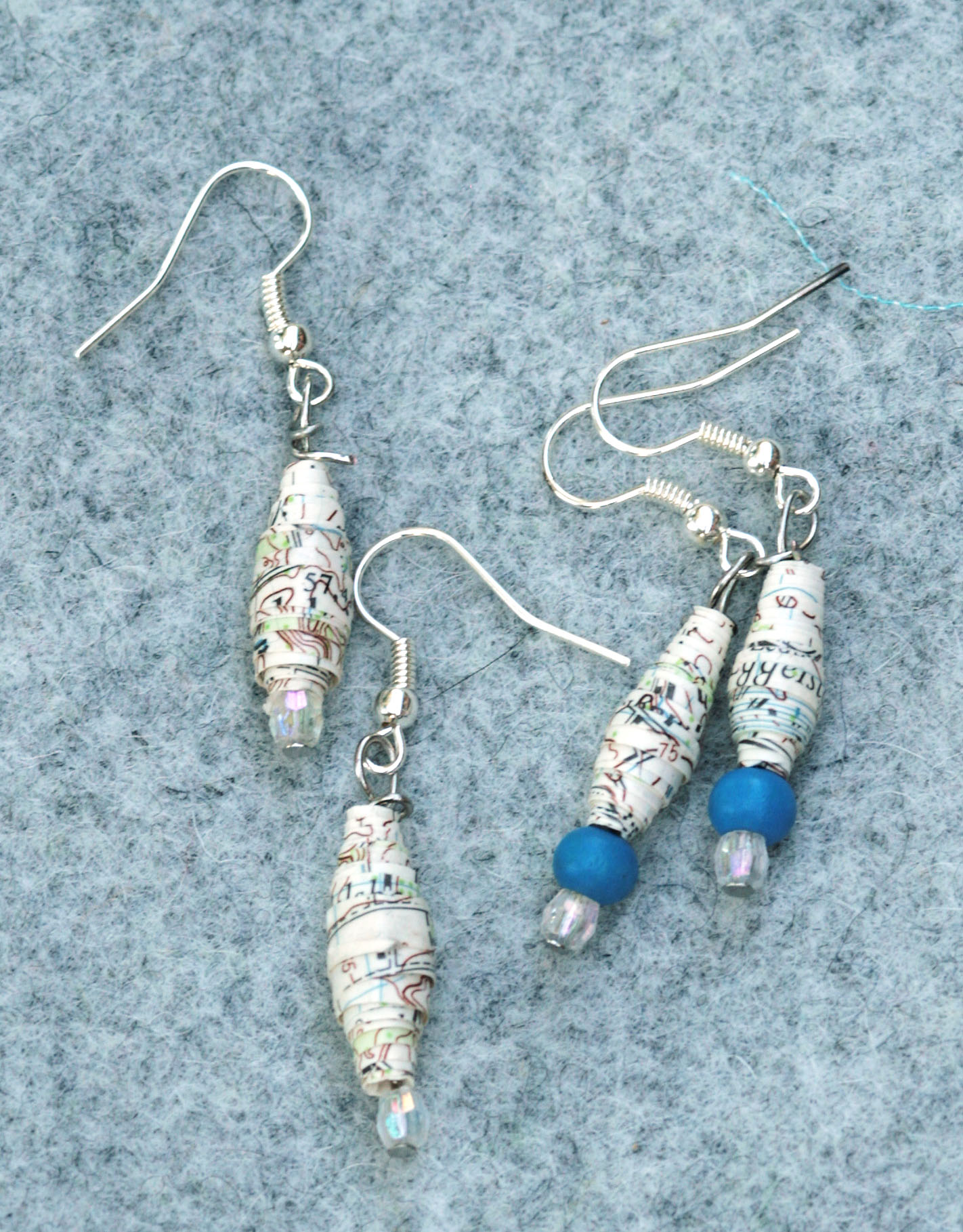 Earrings made of out of date maps.
