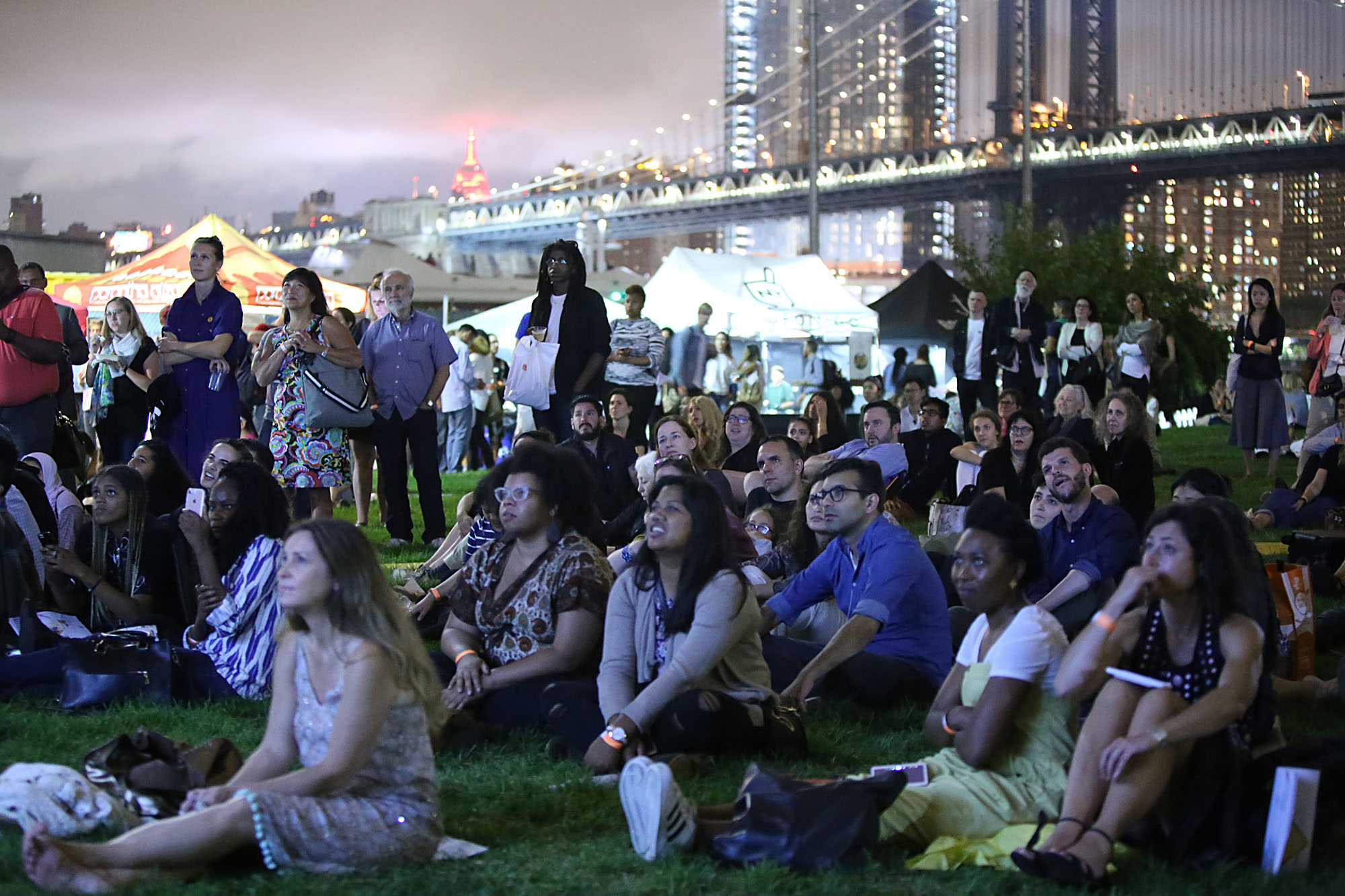  The crowd at Photoville's Beer Garden watches Newest Americans projections on Opening Night. (Photo by Anthony Alvarez) 