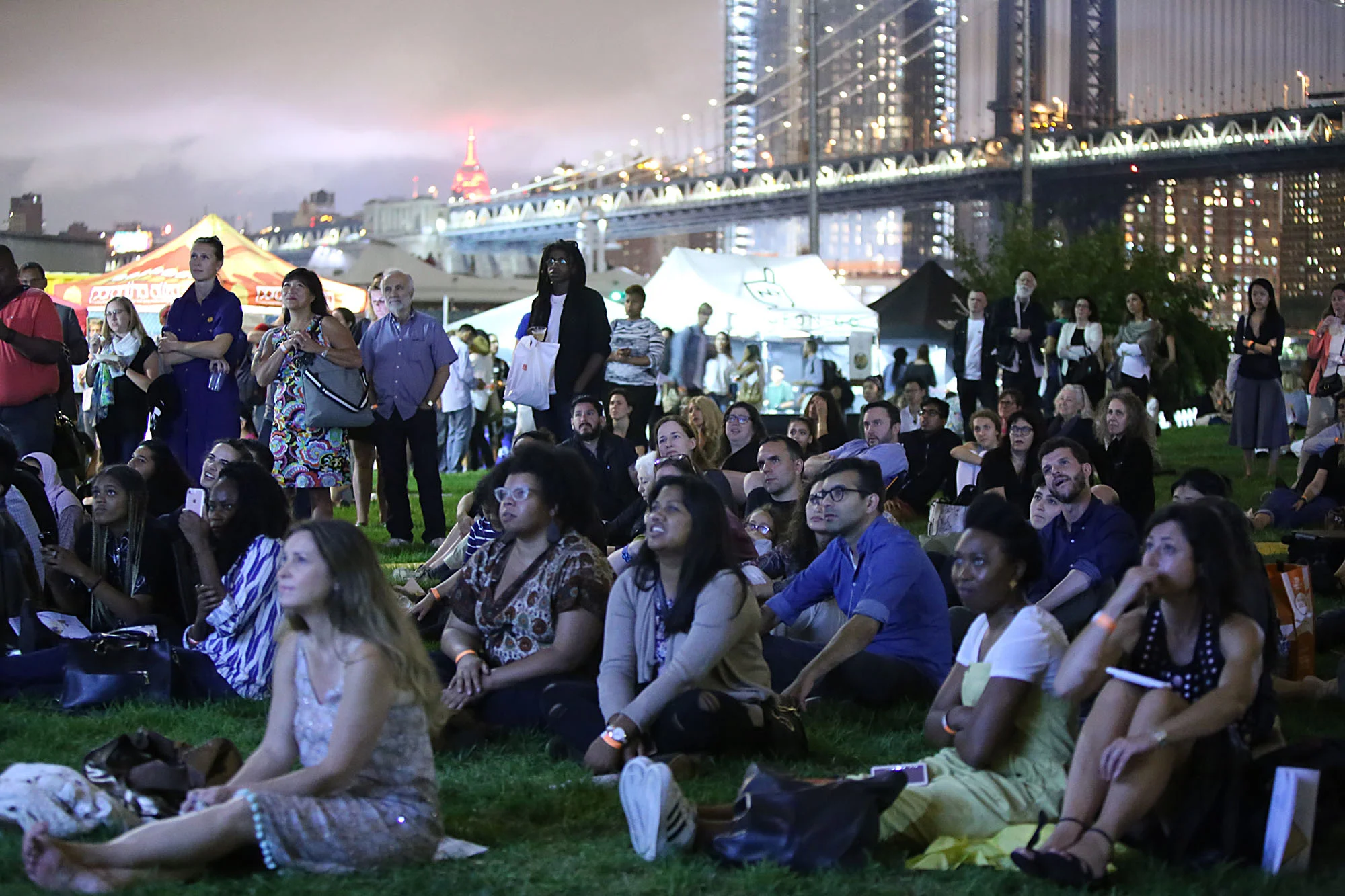 The crowd at Photoville's Beer Garden watches Newest Americans projections on Opening Night. (Photo by Anthony Alvarez)