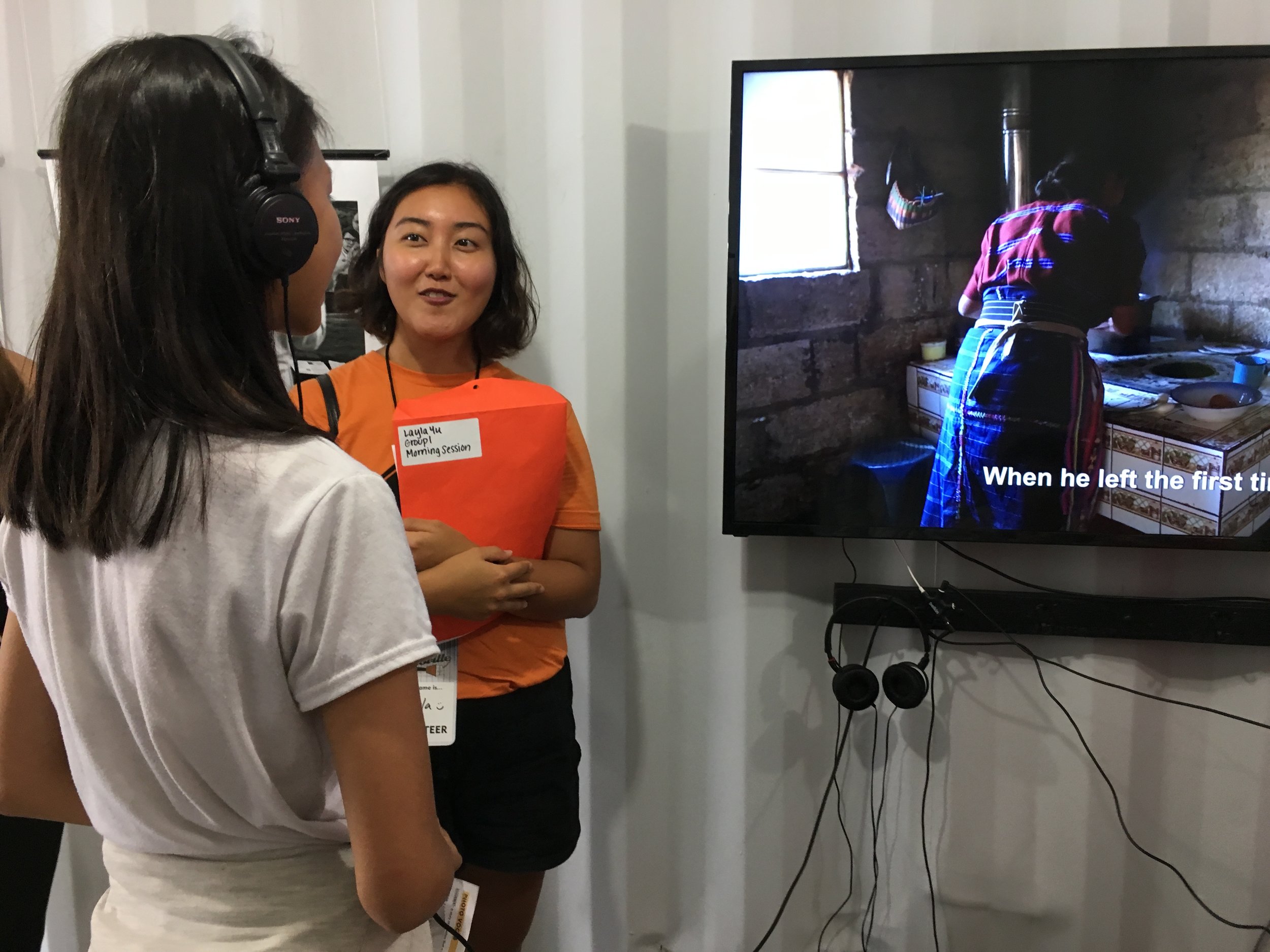  A Photoville volunteer prompts students with questions about their own immigrant backgrounds at the Newest Americans exhibit on Education Day, when over 500 students visited the photo village for an inside look at the exhibitions, artists and curato