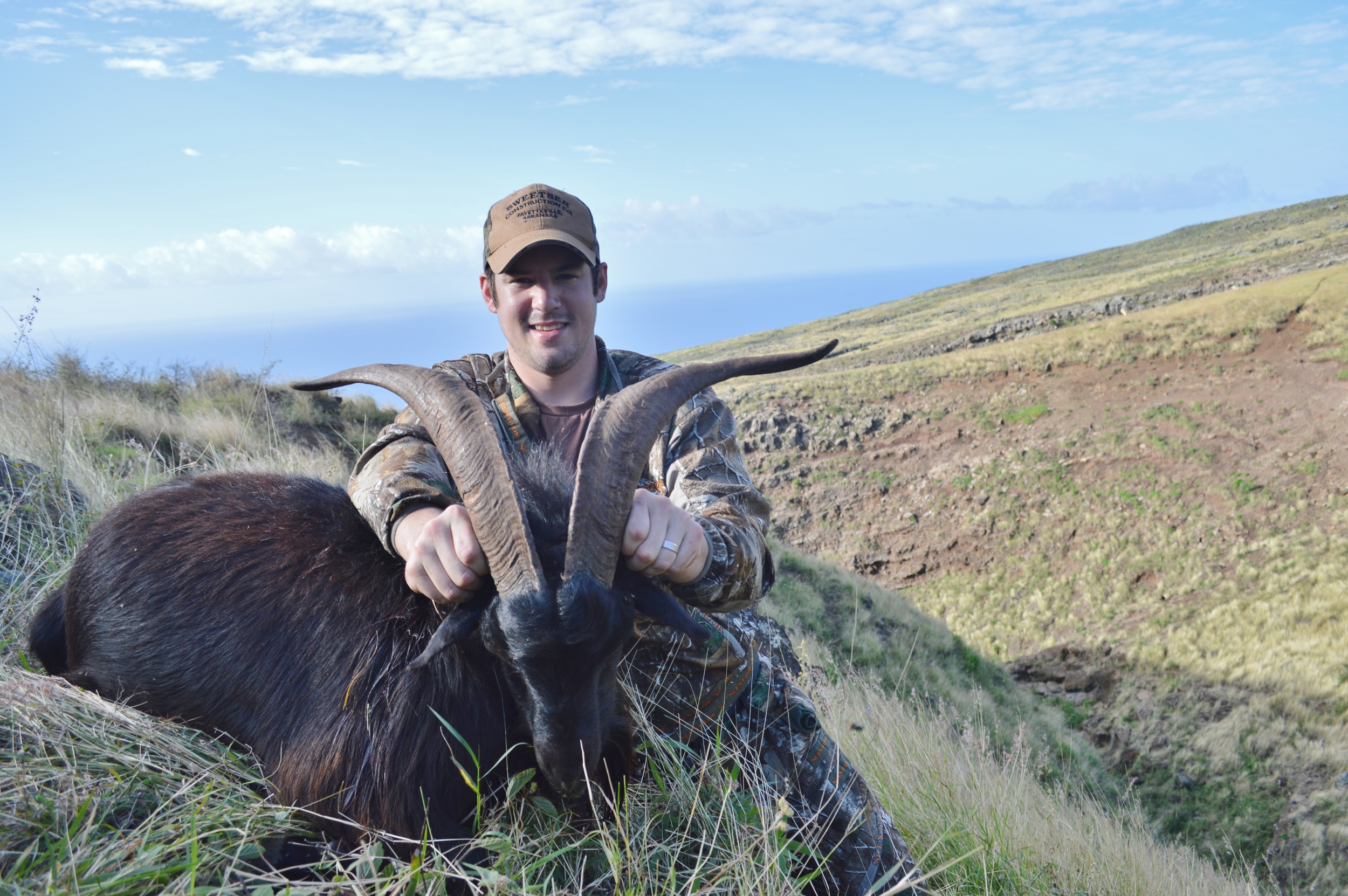 ‘Good’ photo example. The animal is clean with the exception of a little mess on his side. I am positioned behind the animal and have my hands behind the horns instead of around them. The background of the photos provides a great setting for the hunt. The camera angle is low, close to eye level with the subject. One improvement for this photo would have been the angle relevant to the sun, notice how my hat has casted a shadow on my face. A high sun photo with a hat can be tricky, waiting for some cloud cover would have been ideal. Removing some of the foreground grasses would have also helped.