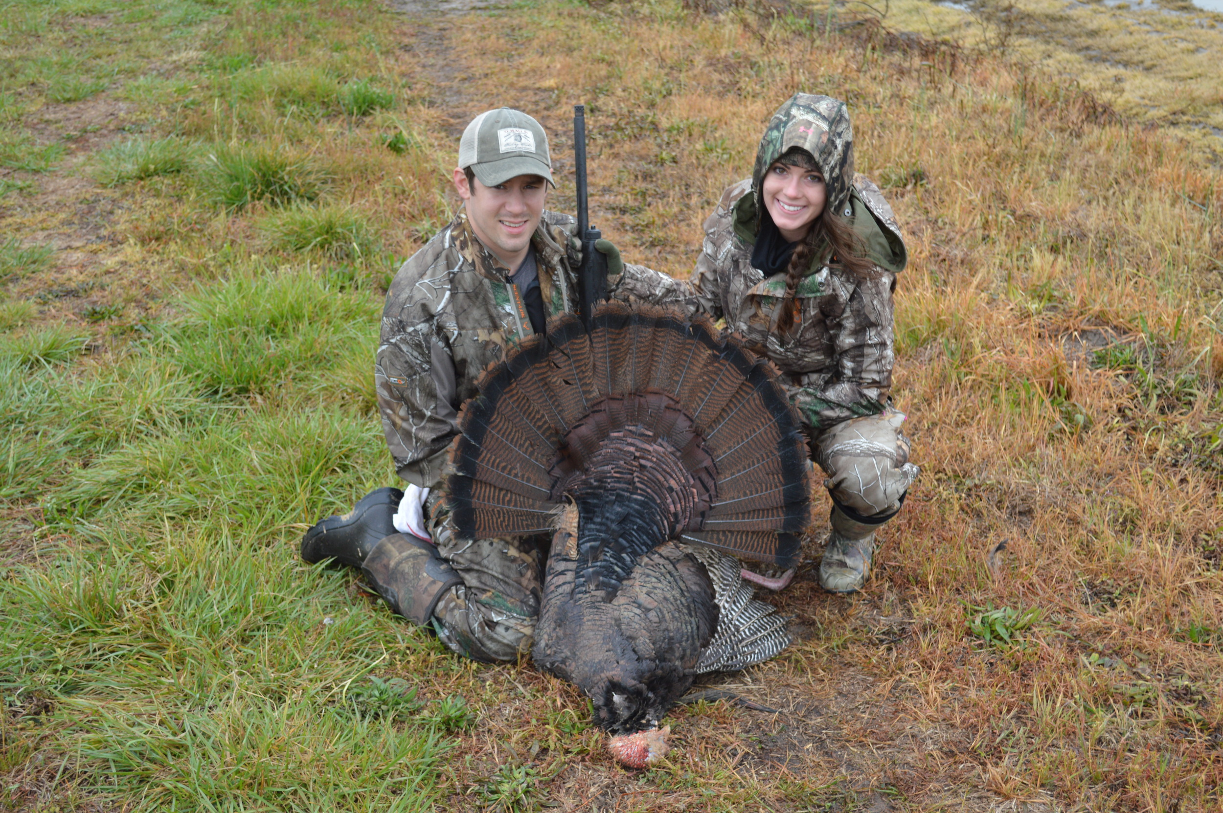 Here is a prime example of what a huge difference camera angle makes . In this shot I had to nag at my buddy to get on the ground and take the photo closer to eye level with the turkey. While my wife isn’t on her butt, the kneeling pose seemed to have worked out on this one. Also notice it was an overcast day so the shadows, even with a hat are minimal when compared to the first two photos in this article. We took the time on this photo, it now hangs on our wall.