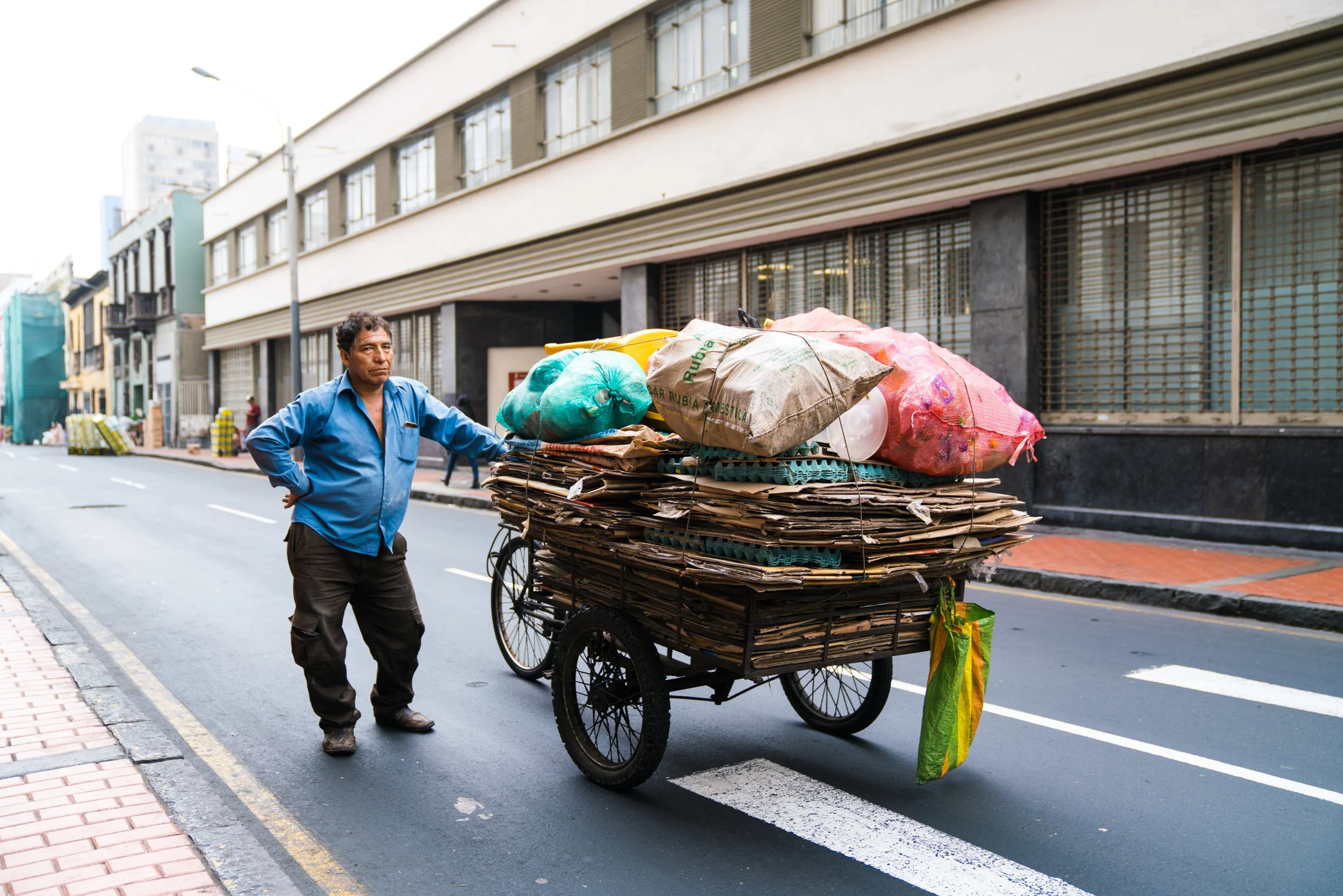 A Peruvian man transports recycling across the city. Lima, Peru. 2018