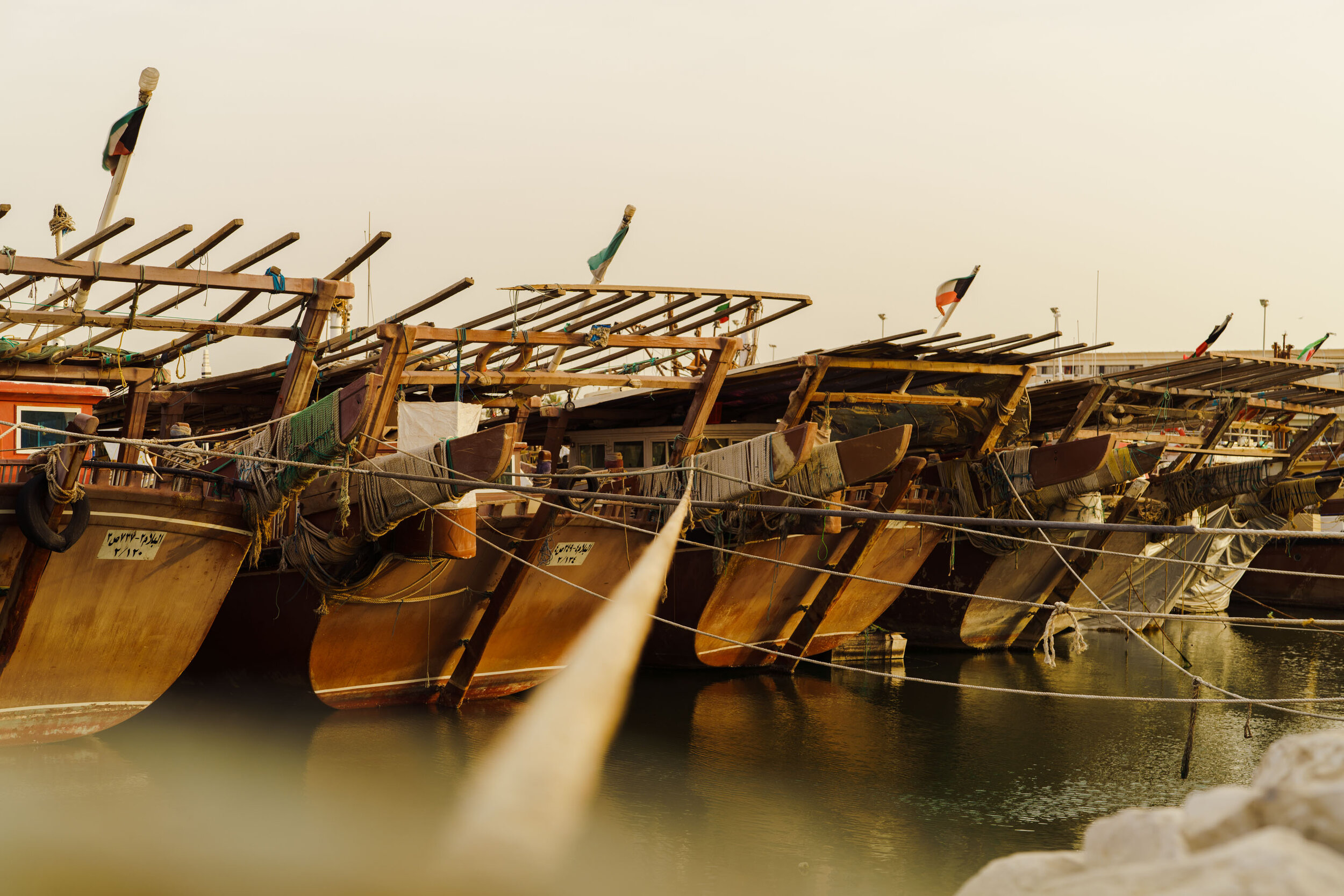  Dhow boats tied to the port sides with ropes.  