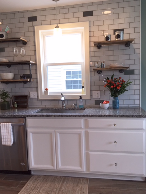 Zoom in to see the glass tile backsplash and reclaimed wood shelving
