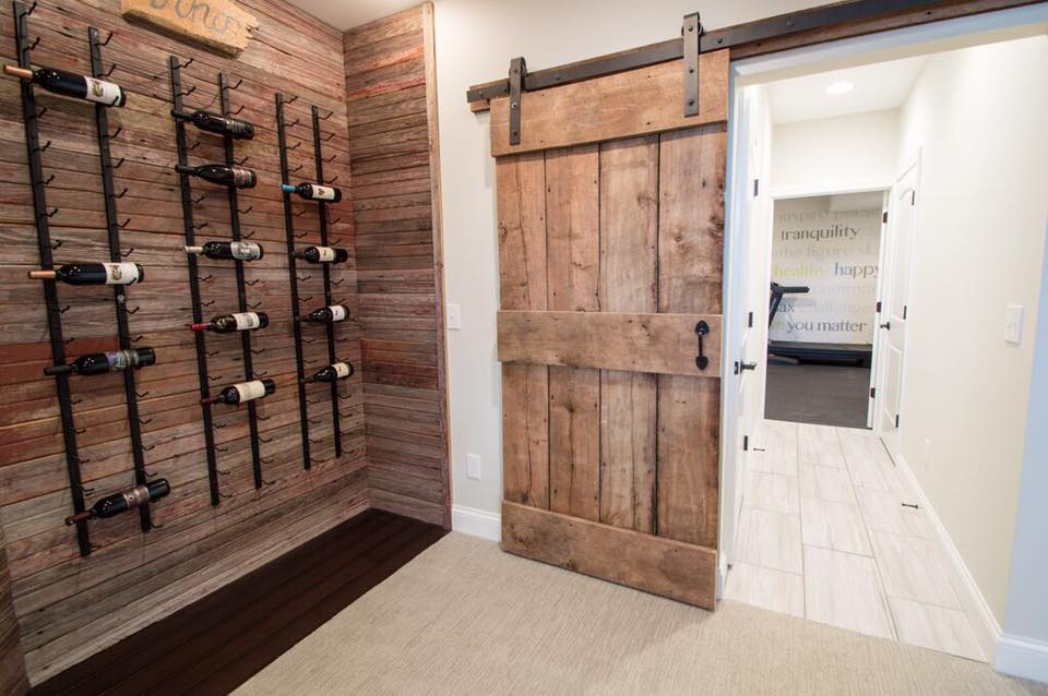  This was a large basement remodel, about 1,800 sq ft. This reclaimed wood wall for wine was one of his favorite projects, along with custom building the slider "barn style" door.&nbsp; 