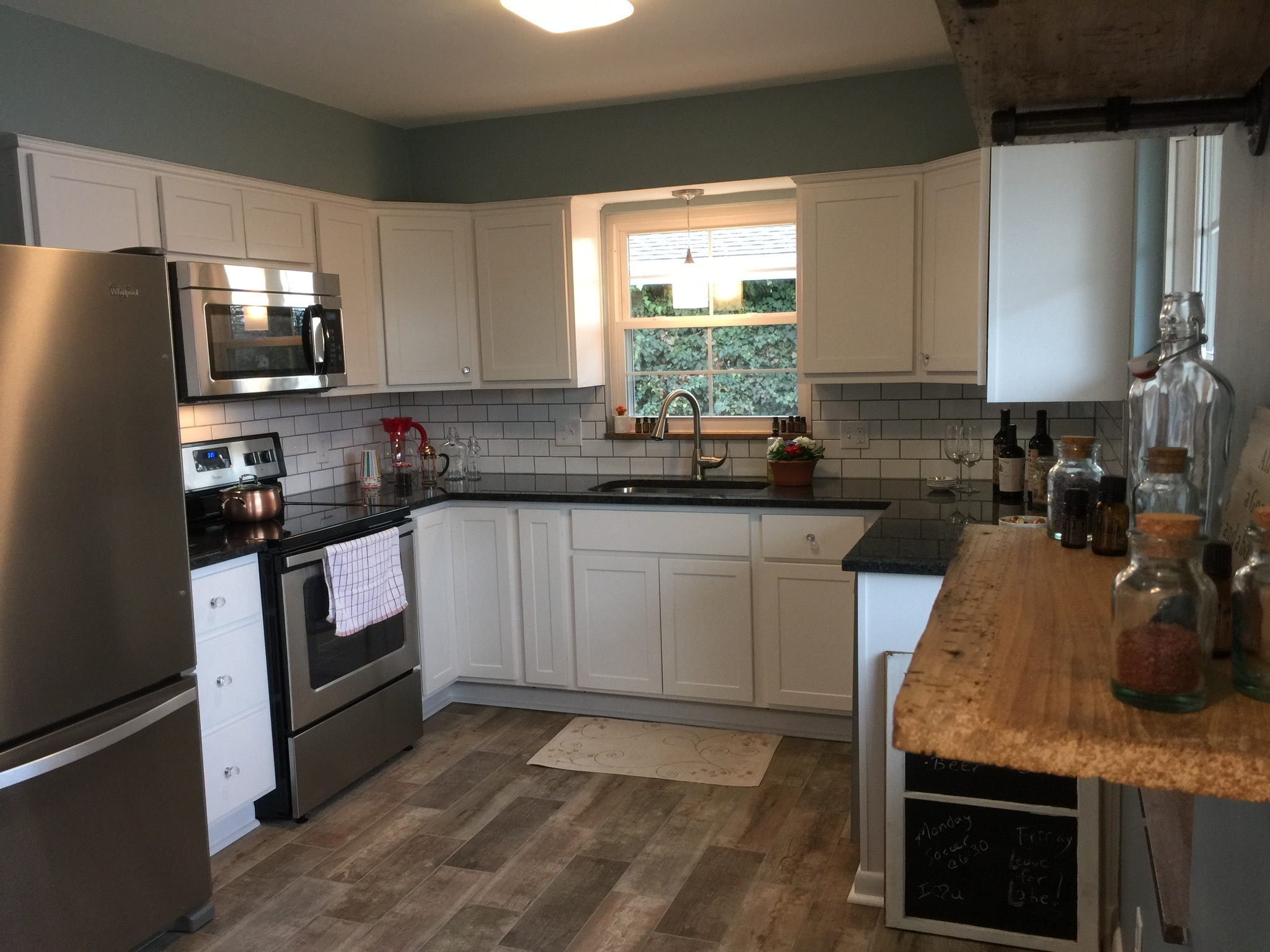 One of our recent projects...it's one we did together.  This is a complete kitchen remodel. Tile floor, subway tile backsplash, granite countertops, reclaimed wood shelves! 