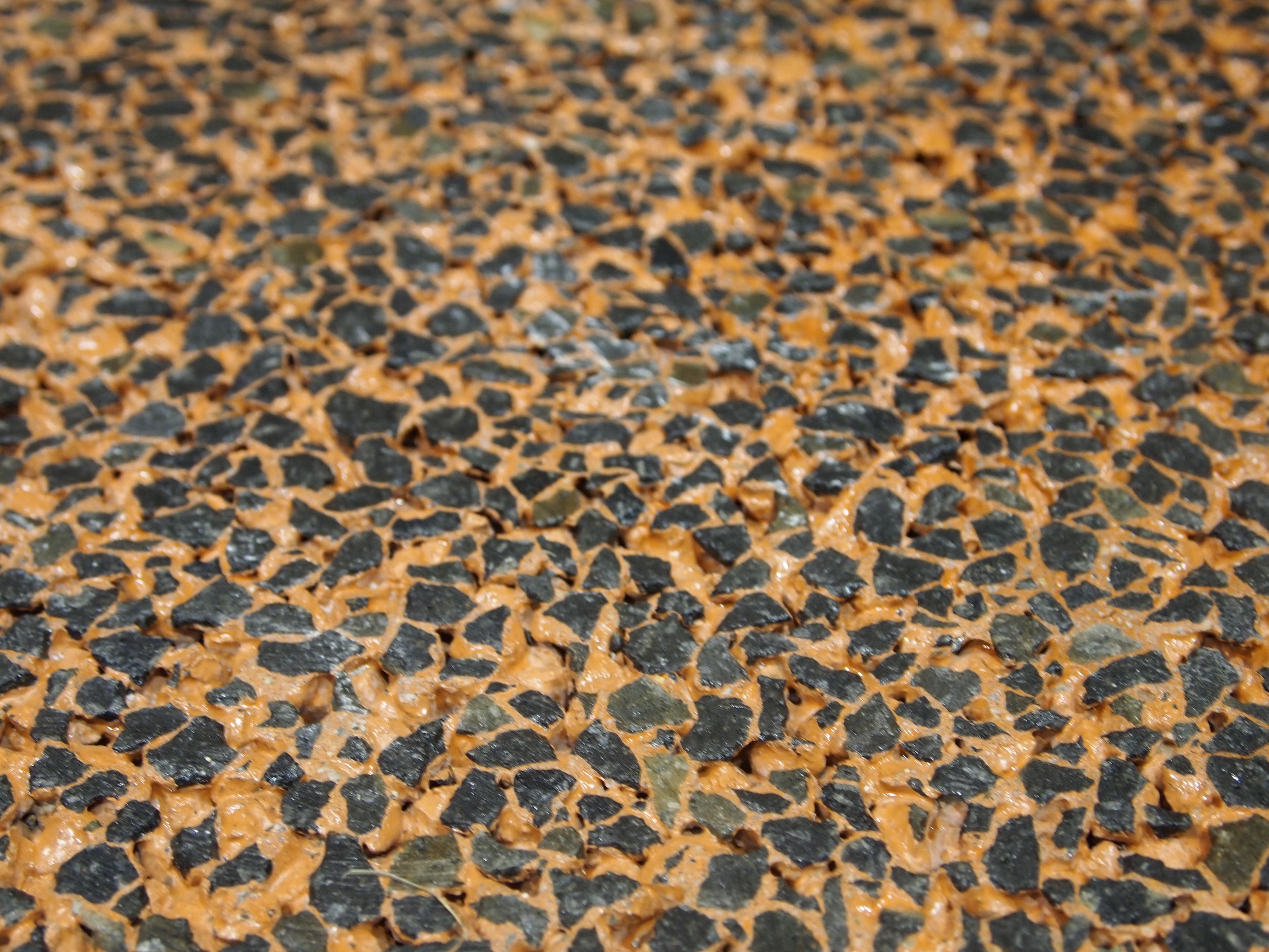 Decorative Colored Polished Pervious Concrete - Basalt aggregate with orange integral color