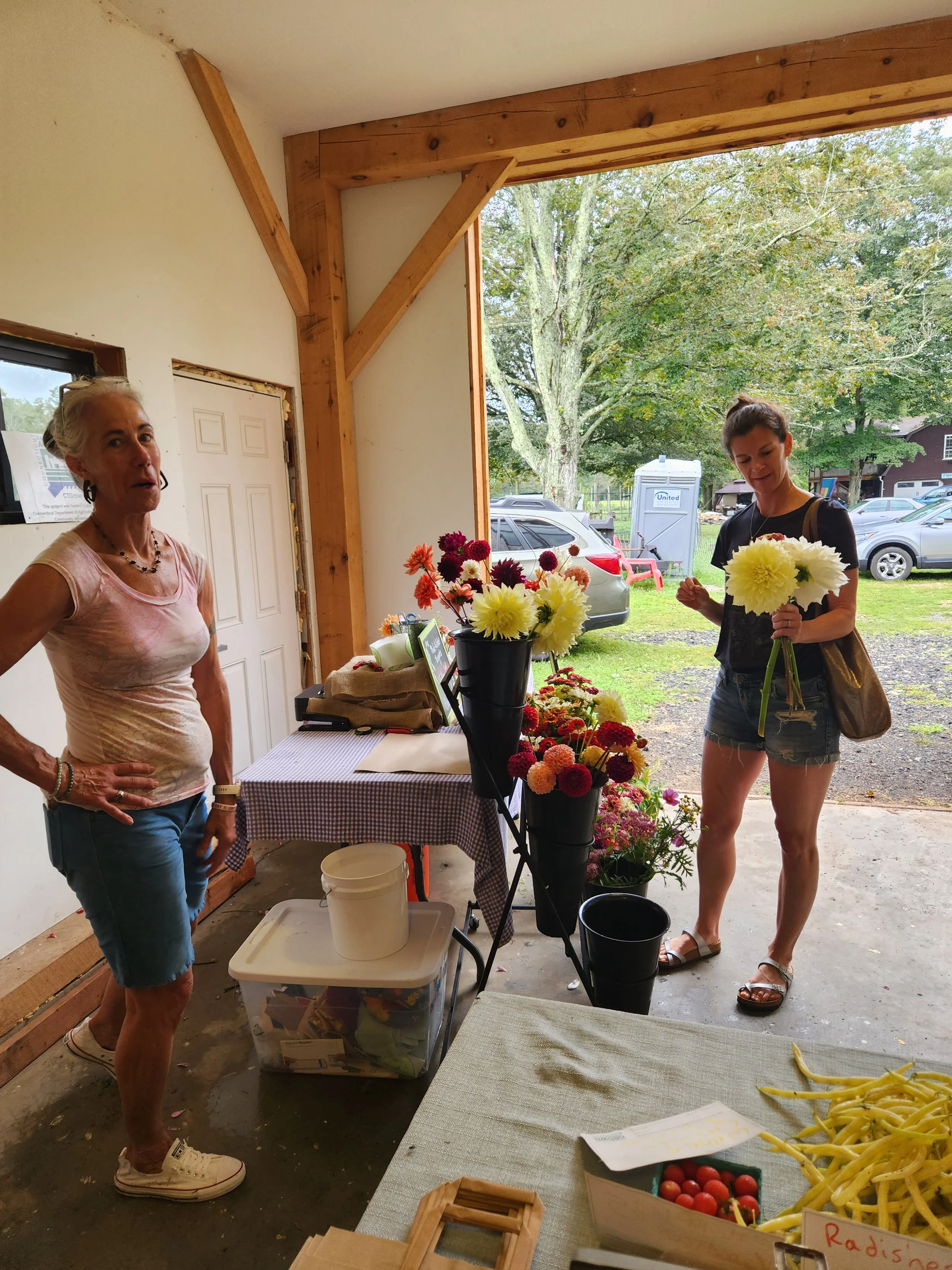 Local urban flower farmer sells at the spring market in the barn at Long Table Farm